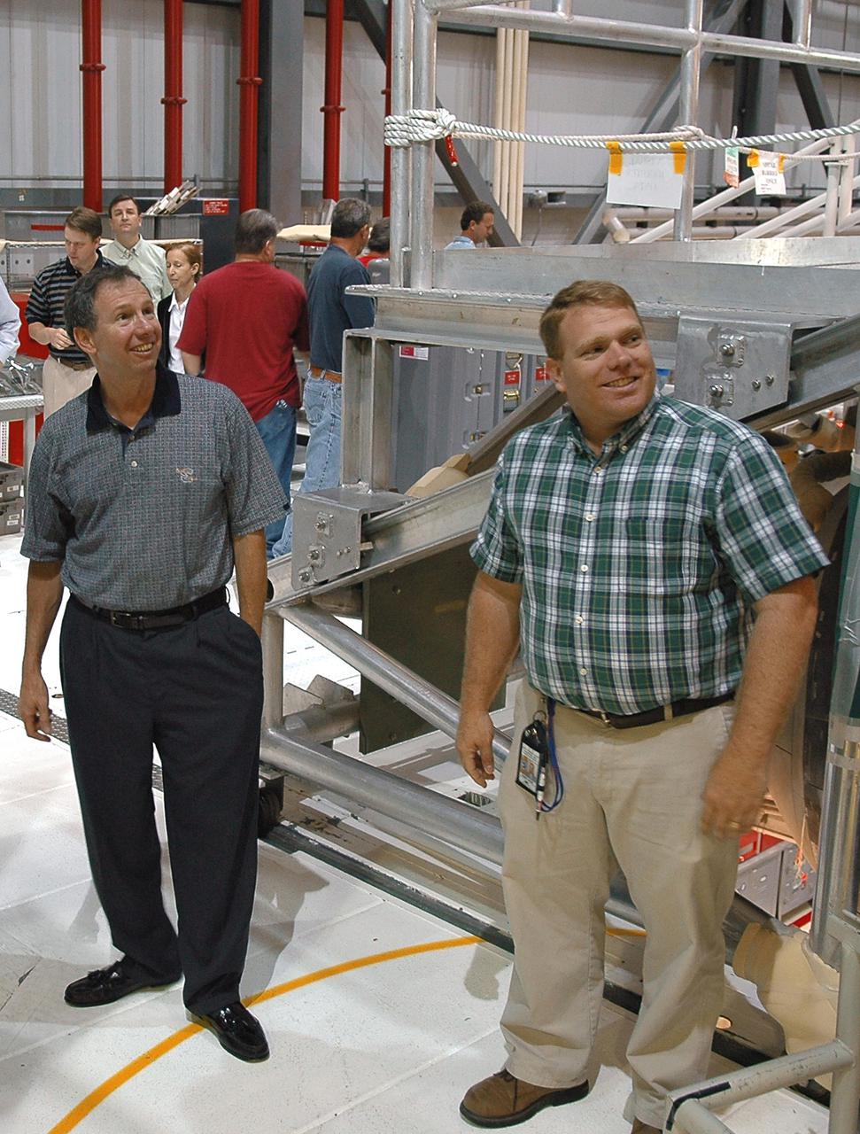 KENNEDY SPACE CENTER, FLA. - NASA Administrator Michael Griffin (left) tours Orbiter Processing Facility bay 1 where Space Shuttle Atlantis is currently being processed for the second Return to Flight mission, STS-121. He is accompanied by NASA ground systems engineer Doug Moore. This is Griffin's first official visit to Kennedy Space Center. Griffin is the 11th administrator of NASA, a role he assumed on April 14, 2005. Griffin was nominated to the position in March while serving as the Space Department head at Johns Hopkins University's Applied Physics Laboratory in Baltimore. A registered professional engineer in Maryland and California, Griffin served as chief engineer at NASA earlier in his career. He holds numerous scientific and technical degrees including a Ph.D. in Aerospace Engineering from the University of Maryland.