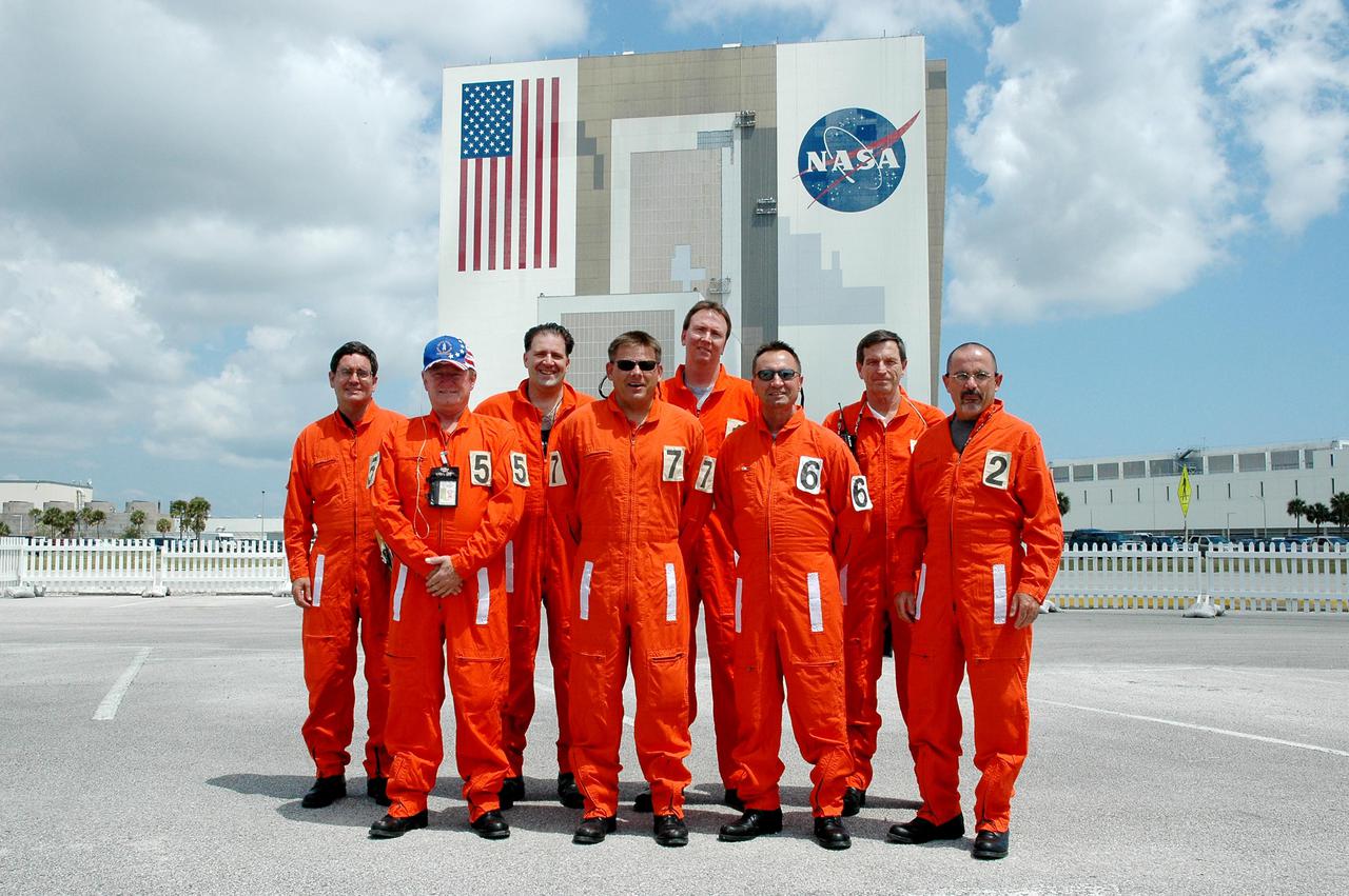 KENNEDY SPACE CENTER, FLA. - Members of the Final Inspection Team pose for a group portrait following their return from Launch Pad 39B where they were supporting an External Tank (ET) tanking test. From left are Robert Speece, NASA; Ray Brewer; United Space Alliance; Mike Payne, NASA; Scott Otto, Lockheed Martin; John Blue, NASA; Doug Powell, Lockheed Martin; William Duckworth, United Space Alliance; and Jorge Rivera, NASA. This team conducts a preflight walkdown of the vehicle and pad during the hold at T-3 hours on launch day. The tanking test is designed to evaluate how the tank, orbiter, solid rocket boosters and ground systems perform under 'cryo-load,' when the tank is filled with the two ultra-low-temperature propellants. The tank filling and draining portion of the test takes about 11 hours. The test also includes a simulated countdown through the hold at T-31 seconds. The test is being conducted to troubleshoot two issues identified by a tanking test held on April 14. Data is being collected to analyze the liquid hydrogen sensors that gave intermittent readings and the liquid hydrogen pressurization relief valve that cycled more times than standard. The tanking tests are part of preparations for Space Shuttle Discovery's Return to Flight mission, STS-114, to the International Space Station. The launch window extends from July 13 through July 31.