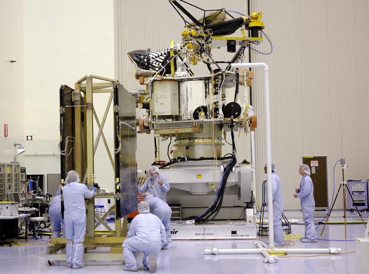 KENNEDY SPACE CENTER, FLA. - In the Payload Hazardous Servicing Facility, technicians position the solar arrays for the Mars Reconnaissance Orbiter (MRO) in preparation for an electromagnetic interference verification test.  If no interference is found during the test, the Shallow Radar Antenna (SHARAD) will be installed on the spacecraft. The spacecraft is undergoing multiple mechanical assembly operations and electrical tests to verify its readiness for launch. The MRO was built by Lockheed Martin for NASA’s Jet Propulsion Laboratory in California. It is the next major step in Mars exploration and scheduled for launch from Launch Complex 41 at Cape Canaveral Air Force Station in a window opening Aug. 10. The MRO is an important next step in fulfilling NASA’s vision of space exploration and ultimately sending human explorers to Mars and beyond.