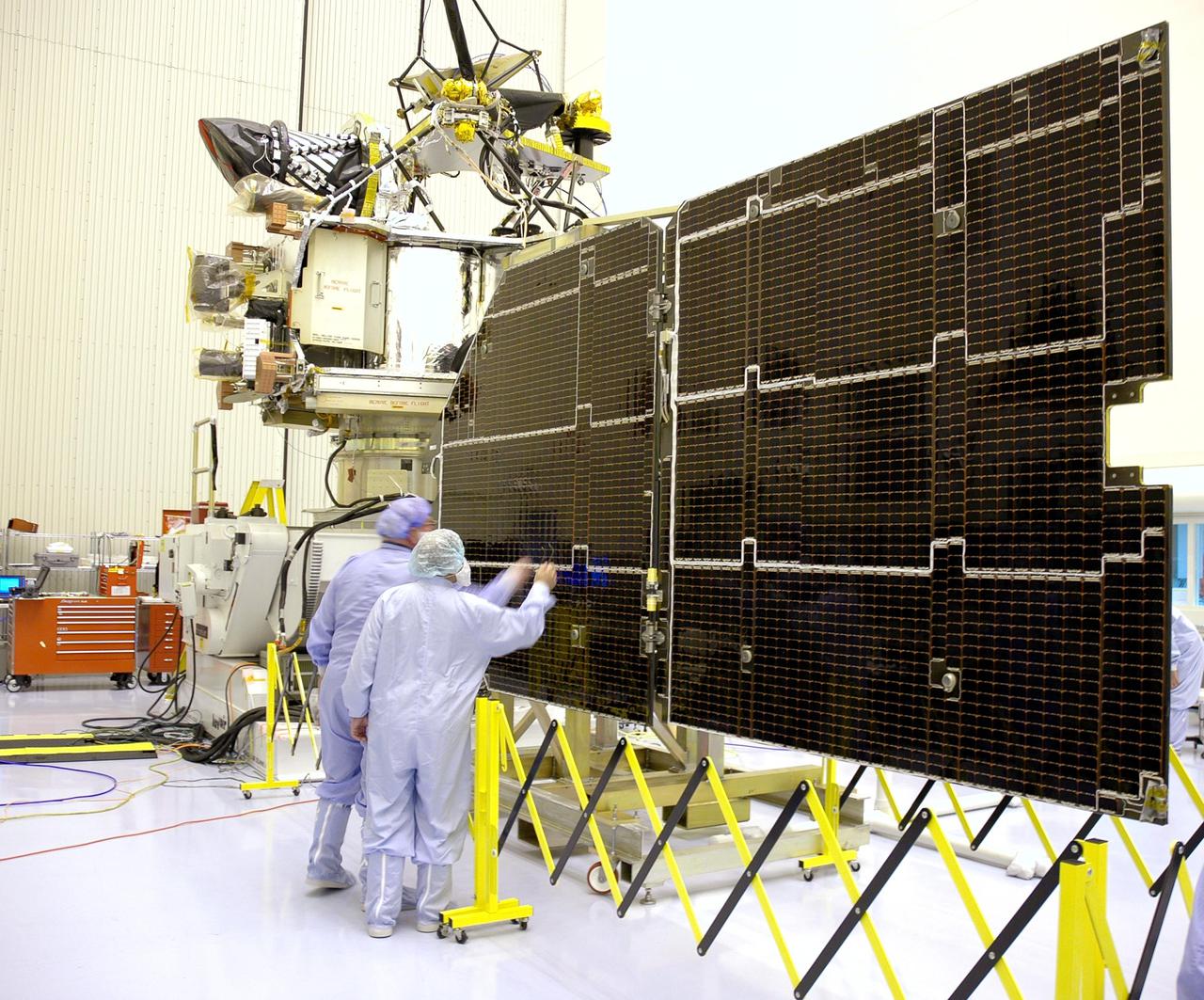 KENNEDY SPACE CENTER, FLA. - In the Payload Hazardous Servicing Facility, technicians inspect the solar panels for the Mars Reconnaissance Orbiter (MRO) during an electromagnetic interference verification test.  If no interference is found during the test, the Shallow Radar Antenna (SHARAD) will be installed on the spacecraft. The spacecraft is undergoing multiple mechanical assembly operations and electrical tests to verify its readiness for launch. The MRO was built by Lockheed Martin for NASA’s Jet Propulsion Laboratory in California. It is the next major step in Mars exploration and scheduled for launch from Launch Complex 41 at Cape Canaveral Air Force Station in a window opening Aug. 10. The MRO is an important next step in fulfilling NASA’s vision of space exploration and ultimately sending human explorers to Mars and beyond.