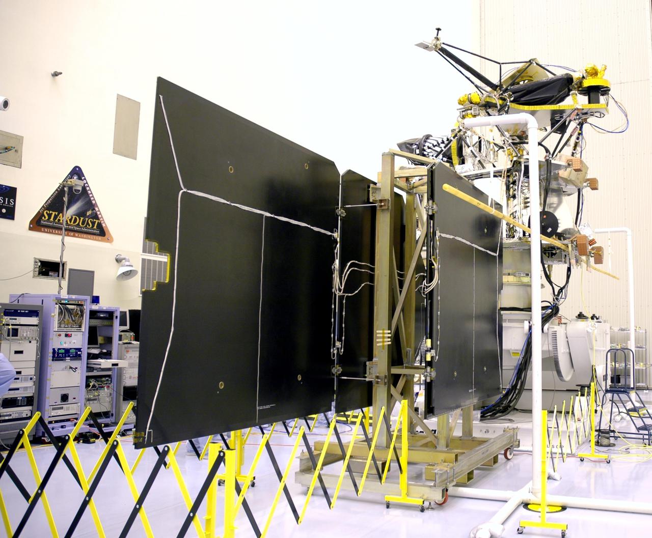 KENNEDY SPACE CENTER, FLA. - In the Payload Hazardous Servicing Facility, an electromagnetic interference verification test is being conducted on the solar arrays for the Mars Reconnaissance Orbiter (MRO) and an antenna simulator (yellow horizontal rod).  If no interference is found during the test, the Shallow Radar Antenna (SHARAD) will be installed on the spacecraft. The spacecraft is undergoing multiple mechanical assembly operations and electrical tests to verify its readiness for launch. The MRO was built by Lockheed Martin for NASA’s Jet Propulsion Laboratory in California. It is the next major step in Mars exploration and scheduled for launch from Launch Complex 41 at Cape Canaveral Air Force Station in a window opening Aug. 10. The MRO is an important next step in fulfilling NASA’s vision of space exploration and ultimately sending human explorers to Mars and beyond.