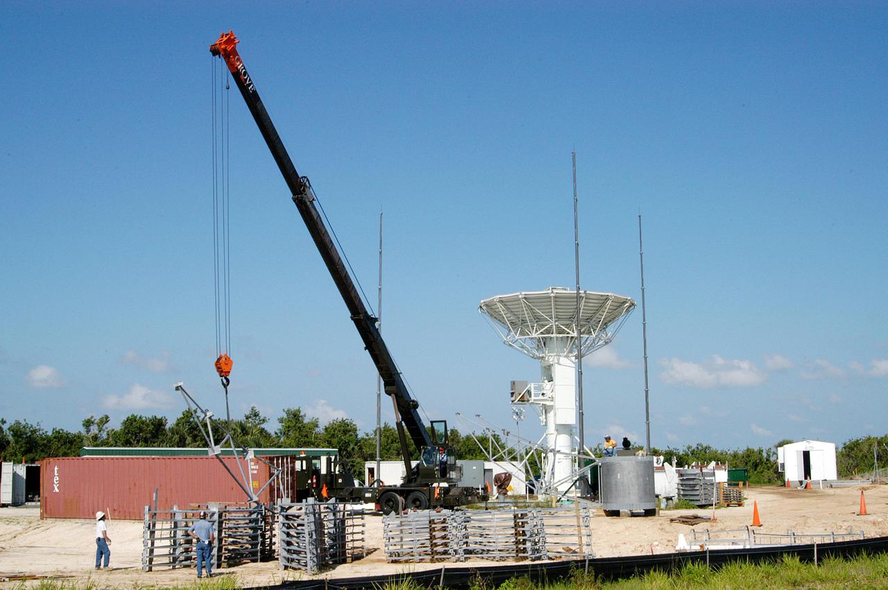 KENNEDY SPACE CENTER, FLA. - At a radar site on North Merritt Island, Fla., north of the Haulover Canal, a 50-foot dish for NASA’s C-band radar is being assembled. The radar will be used for long-term Shuttle missions to track the launches and observe possible debris coming from the Shuttle. In the background is an existing 30-foot C-band Pathfinder radar whose use was demonstrated on the Delta Messenger launch. It will be used on the upcoming two Return to Flight missions. The launch window for the first Return to Flight mission, STS-114, is July 13 to July 31.