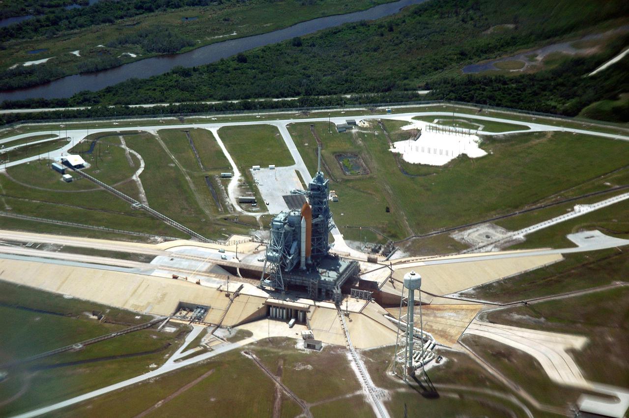KENNEDY SPACE CENTER, FLA.  -  An aerial view of Launch Pad 39B and surrounding area at NASA's Kennedy Space Center, showing the Space Shuttle Discovery at center.  This is one of a series of photos shot cross-cockpit from a NASA Gulfstream 2.  Photo Credit: NASA_Richard Clark. (JSC2005-E-16173)
