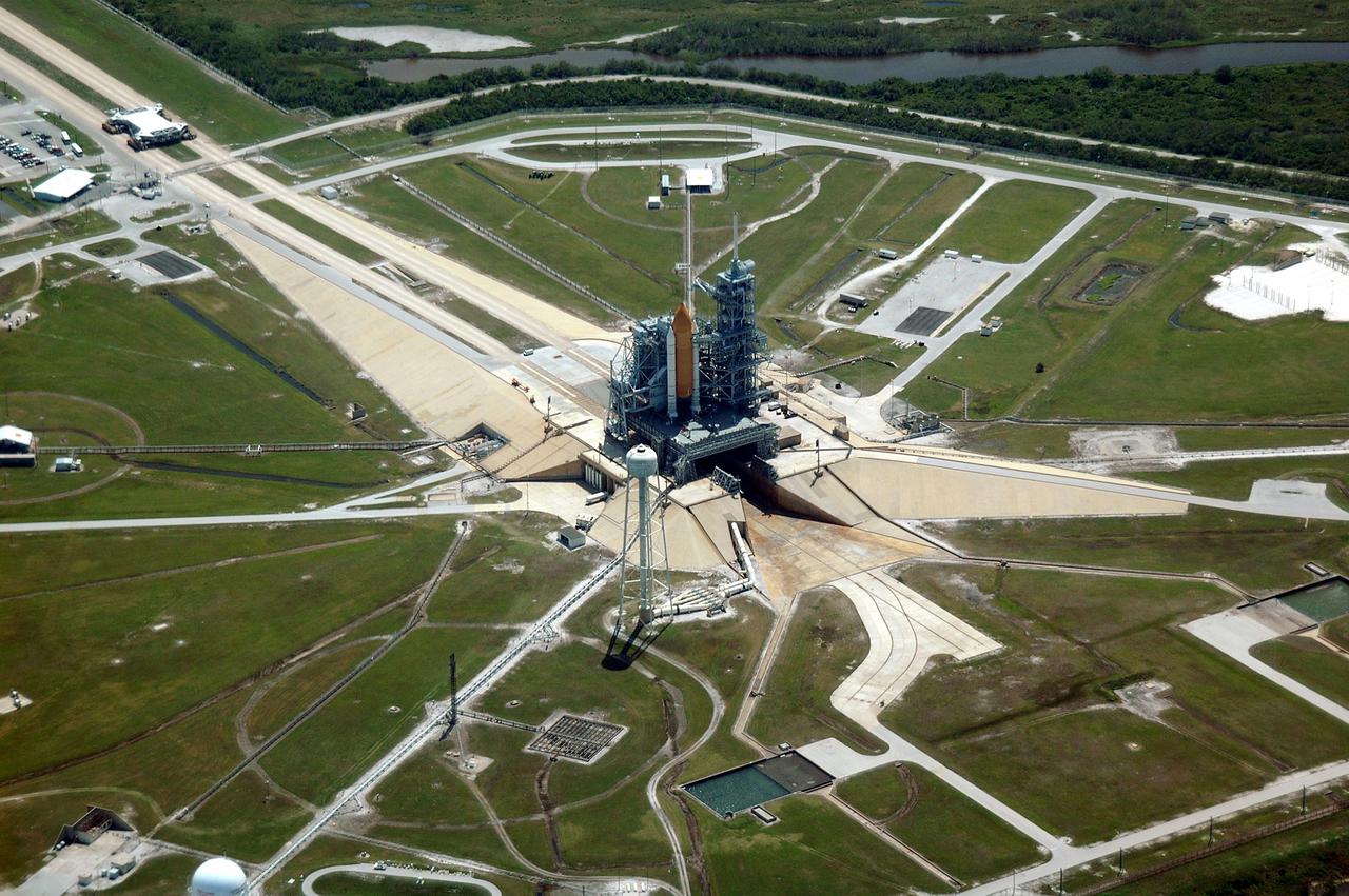 KENNEDY SPACE CENTER, FLA.  -  An aerial view of Launch Pad 39B and surrounding area at NASA's Kennedy Space Center, showing the Space Shuttle Discovery at center.  This is one of a series of photos shot cross-cockpit from a NASA Gulfstream 2.  Photo Credit: NASA_Richard Clark. (JSC2005-E-16174)