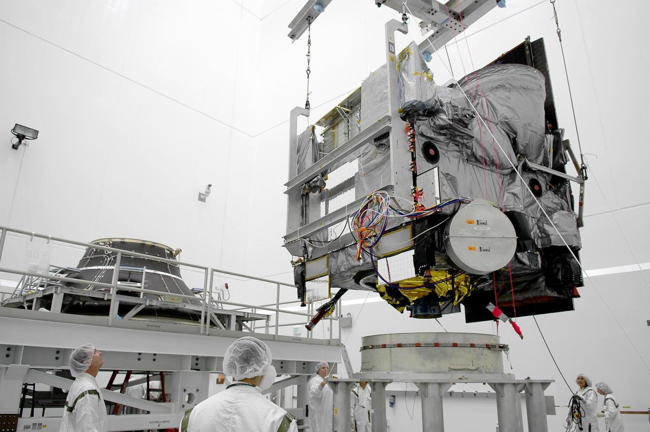 KENNEDY SPACE CENTER, FLA. - At Astrotech Space Operations in Titusville, Fla., the Geostationary Operational Environmental Satellite GOES-N is lifted for mating with the Payload Attach Fitting at left. The fitting will enable the spacecraft to be mated to its launch vehicle, a Boeing Delta IV, with a 3-burn second-stage operation. Since its arrival on March 11, the satellite has been undergoing final testing by Boeing Satellite Systems of the imaging system, instrumentation, communications and power systems. The GOES spacecraft are sponsored by NASA’s Goddard Space Flight Center and the National Oceanic and Atmospheric Administration. GOES-N is targeted to launch June 23 from Launch Complex 37 at Cape Canaveral Air Force Station in Florida.
