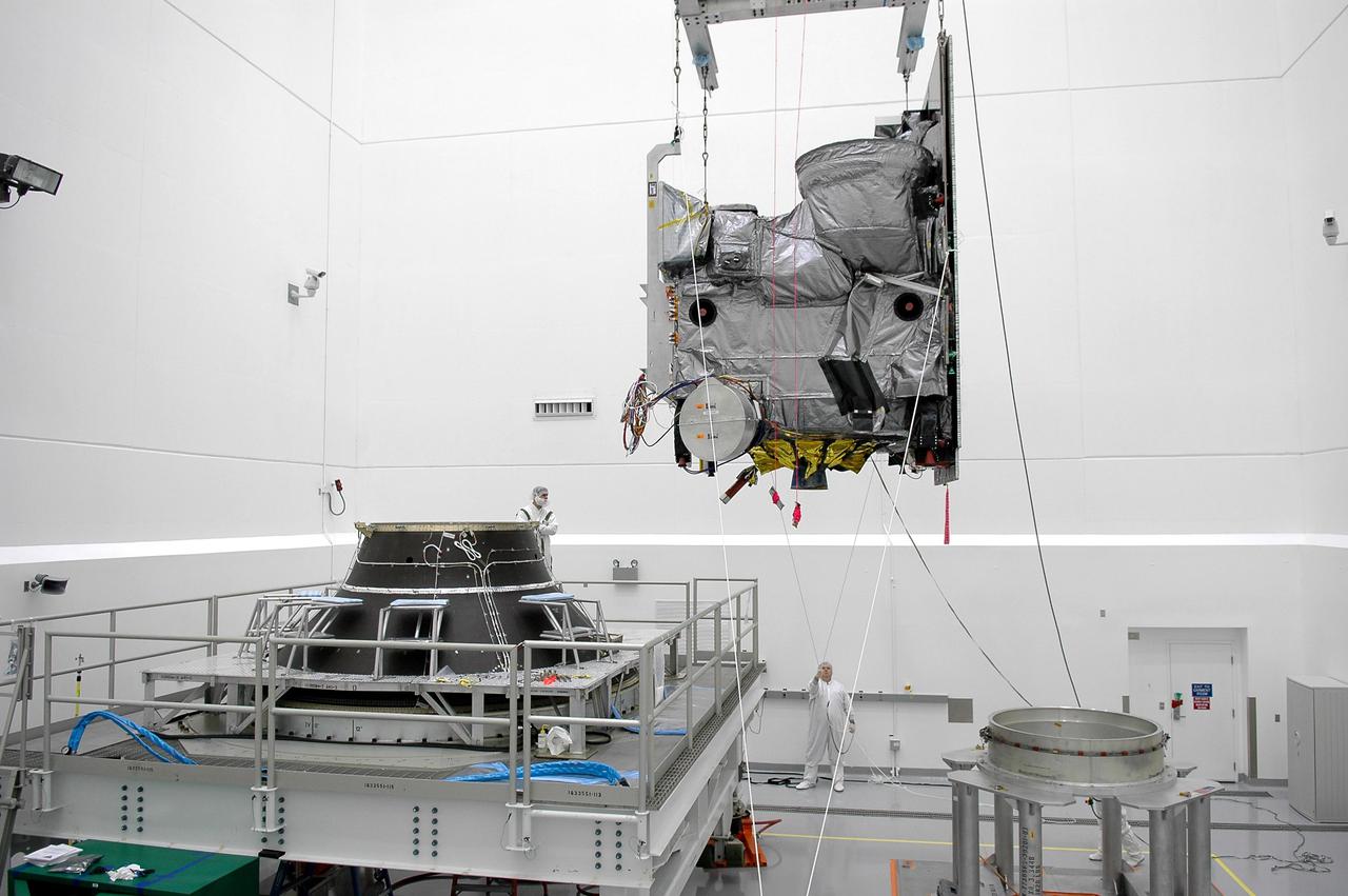 KENNEDY SPACE CENTER, FLA. - At Astrotech Space Operations in Titusville, Fla., the Geostationary Operational Environmental Satellite GOES-N is moved toward the Payload Attach Fitting at left for mating. The fitting will enable the spacecraft to be mated to its launch vehicle, a Boeing Delta IV, with a 3-burn second-stage operation. Since its arrival on March 11, the satellite has been undergoing final testing by Boeing Satellite Systems of the imaging system, instrumentation, communications and power systems. The GOES spacecraft are sponsored by NASA’s Goddard Space Flight Center and the National Oceanic and Atmospheric Administration. GOES-N is targeted to launch June 23 from Launch Complex 37 at Cape Canaveral Air Force Station in Florida.