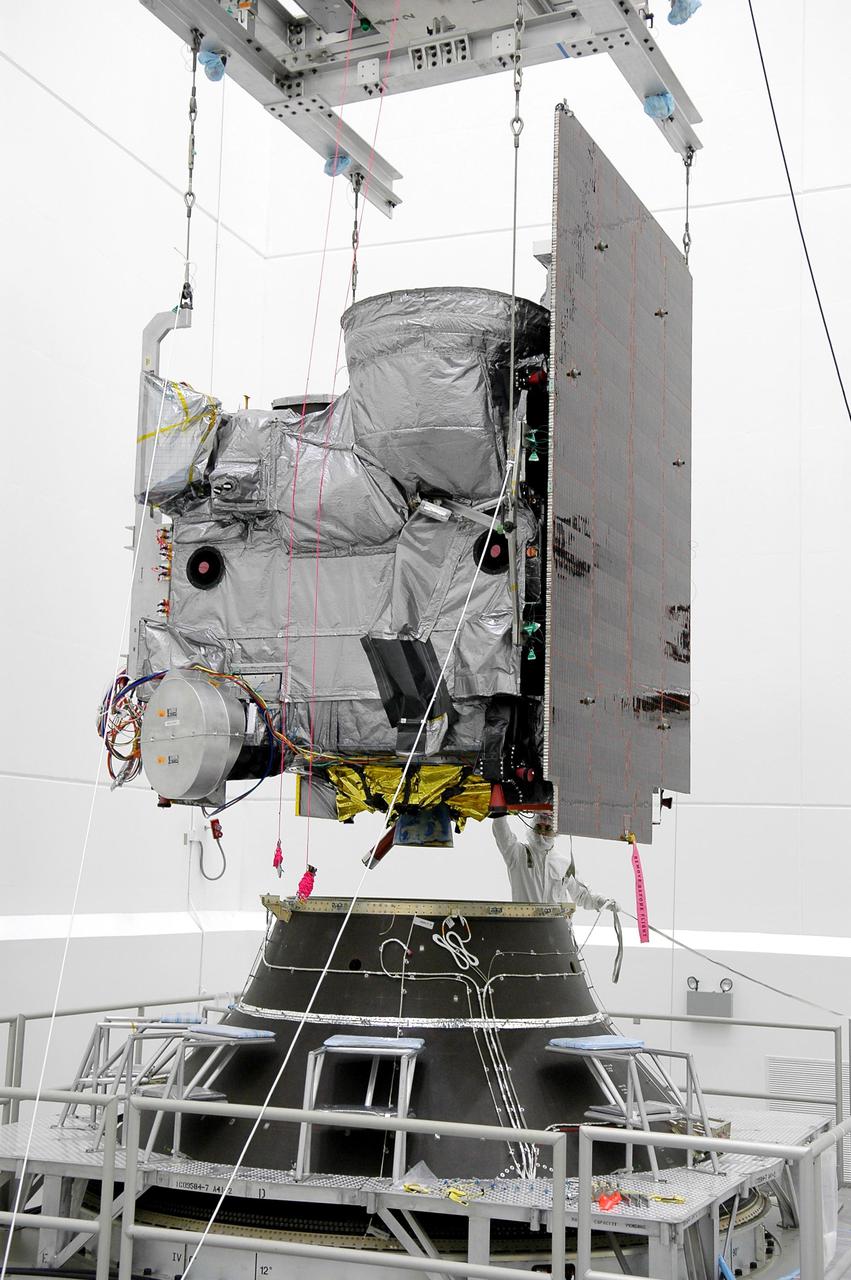 KENNEDY SPACE CENTER, FLA. - At Astrotech Space Operations in Titusville, Fla., the Geostationary Operational Environmental Satellite GOES-N is lowered toward the Payload Attach Fitting for mating. The fitting will enable the spacecraft to be mated to its launch vehicle, a Boeing Delta IV, with a 3-burn second-stage operation. Since its arrival on March 11, the satellite has been undergoing final testing by Boeing Satellite Systems of the imaging system, instrumentation, communications and power systems. The GOES spacecraft are sponsored by NASA’s Goddard Space Flight Center and the National Oceanic and Atmospheric Administration. GOES-N is targeted to launch June 23 from Launch Complex 37 at Cape Canaveral Air Force Station in Florida.
