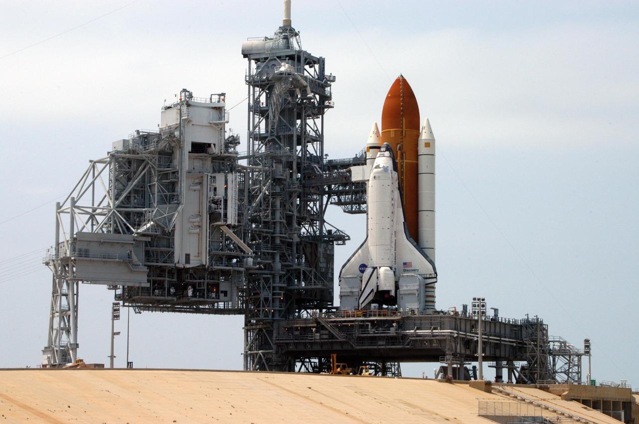 KENNEDY SPACE CENTER, FLA. - On Launch Pad 39B, the Rotating Service Structure is rotated back from Space Shuttle Discovery to prepare for Discovery’s rollback to the Vehicle Assembly Building. Once inside the VAB, Discovery will be demated from its External Tank and lifted into the transfer aisle. On or about June 7, Discovery will be lifted and attached to its new tank and Solid Rocket Boosters, which are already in the VAB. Only the 15th rollback in Space Shuttle Program history, the 4.2-mile journey allows additional modifications to be made to the External Tank prior to a safe Return to Flight. Discovery is expected to be rolled back to the launch pad in mid-June for Return to Flight mission STS-114. The launch window extends from July 13 to July 31.