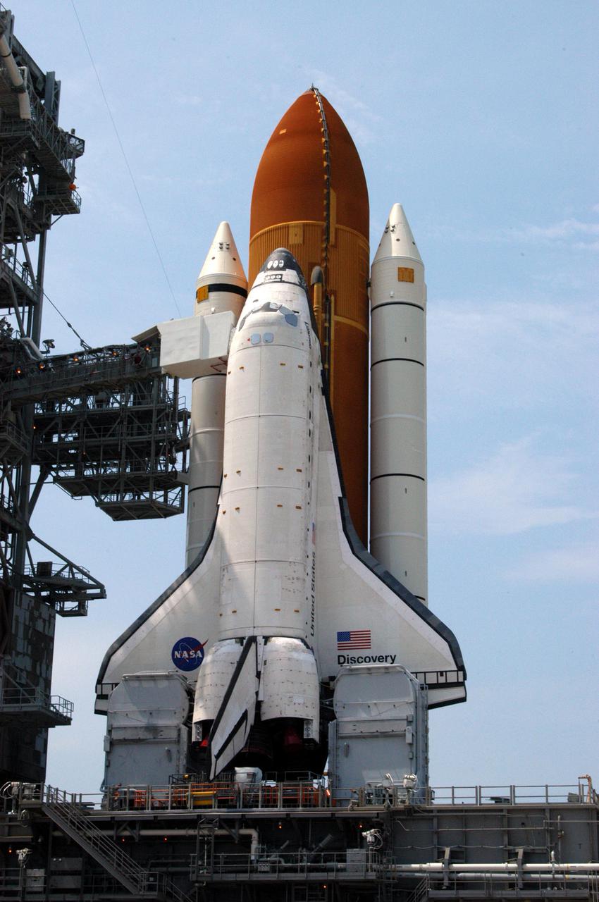 KENNEDY SPACE CENTER, FLA. - On Launch Pad 39B, Space Shuttle Discovery is revealed after rollback of the Rotating Service Structure. Discovery will be rolled back to the Vehicle Assembly Building. Once inside the VAB, Discovery will be demated from its External Tank and lifted into the transfer aisle. On or about June 7, Discovery will be lifted and attached to its new tank and Solid Rocket Boosters, which are already in the VAB. Only the 15th rollback in Space Shuttle Program history, the 4.2-mile journey allows additional modifications to be made to the External Tank prior to a safe Return to Flight. Discovery is expected to be rolled back to the launch pad in mid-June for Return to Flight mission STS-114. The launch window extends from July 13 to July 31.
