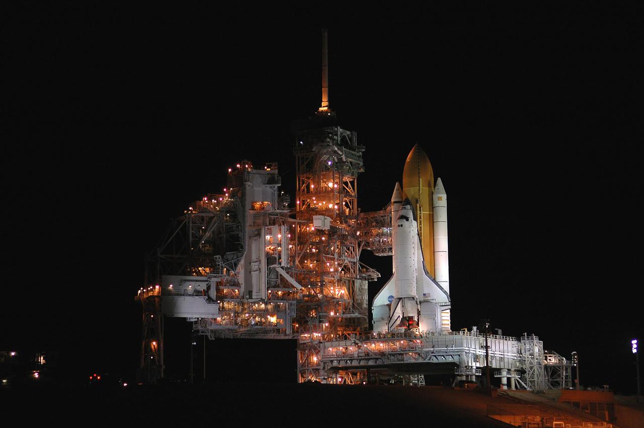 KENNEDY SPACE CENTER, FLA. - In the early morning hours, Space Shuttle Discovery is poised to roll off Launch Pad 39B atop the Crawer_Transporter and roll back to the Vehicle Assembly Building. Once inside the VAB, Discovery will be demated from its External Tank and lifted into the transfer aisle. On or about June 7, Discovery will be lifted and attached to its new tank and Solid Rocket Boosters, which are already in the VAB. Only the 15th rollback in Space Shuttle Program history, the 4.2-mile journey allows additional modifications to be made to the External Tank prior to a safe Return to Flight. Discovery is expected to be rolled back to the launch pad in mid-June for Return to Flight mission STS-114. The launch window extends from July 13 to July 31.