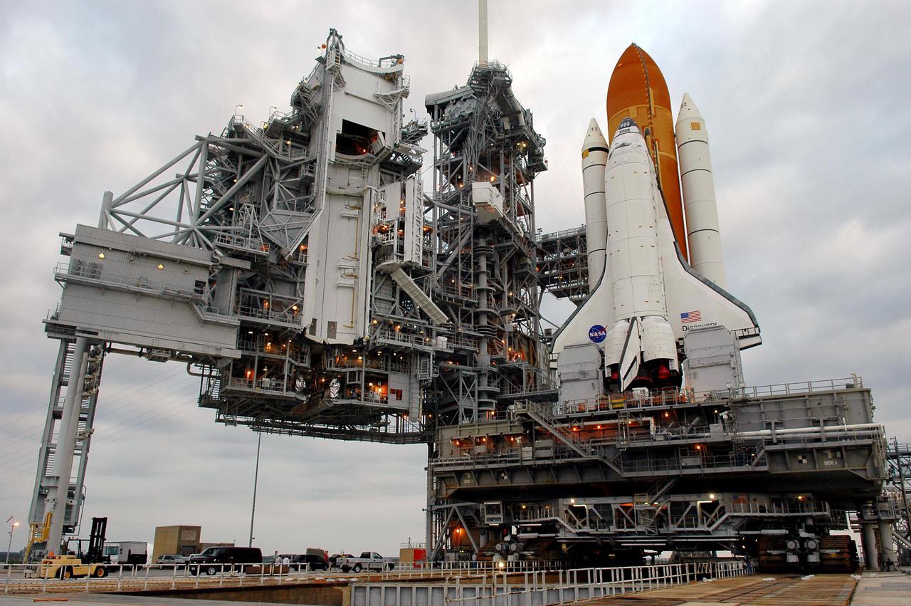 KENNEDY SPACE CENTER, FLA. - After dawn and under cloudy skies, the Crawler_Transporter has moved under Space Shuttle Discovery and the Mobile Launcher Platform for the Shuttle’s rollback to the Vehicle Assembly Building. Once inside the VAB, Discovery will be demated from its External Tank and lifted into the transfer aisle. On or about June 7, Discovery will be lifted and attached to its new tank and Solid Rocket Boosters, which are already in the VAB. Only the 15th rollback in Space Shuttle Program history, the 4.2-mile journey allows additional modifications to be made to the External Tank prior to a safe Return to Flight. Discovery is expected to be rolled back to the launch pad in mid-June for Return to Flight mission STS-114. The launch window extends from July 13 to July 31.