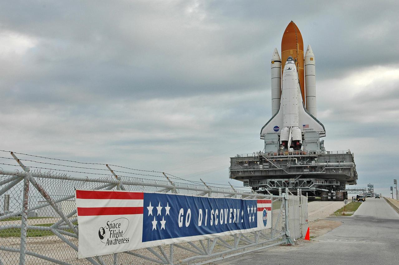 KENNEDY SPACE CENTER, FLA. - Space Shuttle Discovery, resting on the Mobile Launcher Platform atop the Crawler_Transporter, rolls off Launch Pad 39B to the crawlerway on its way back to the Vehicle Assembly Building. Once inside the VAB, Discovery will be demated from its External Tank and lifted into the transfer aisle. On or about June 7, Discovery will be lifted and attached to its new tank and Solid Rocket Boosters, which are already in the VAB. Only the 15th rollback in Space Shuttle Program history, the 4.2-mile journey allows additional modifications to be made to the External Tank prior to a safe Return to Flight. Discovery is expected to be rolled back to the launch pad in mid-June for Return to Flight mission STS-114. The launch window extends from July 13 to July 31.