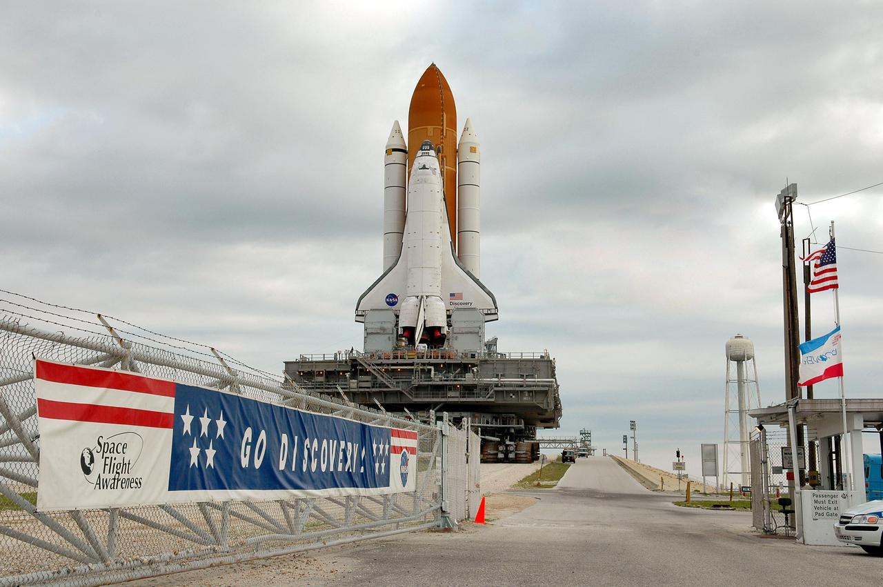 KENNEDY SPACE CENTER, FLA. - Space Shuttle Discovery, resting on the Mobile Launcher Platform atop the Crawler_Transporter, nears the pad gate to Launch Pad 39B on its way back to the Vehicle Assembly Building. Once inside the VAB, Discovery will be demated from its External Tank and lifted into the transfer aisle. On or about June 7, Discovery will be lifted and attached to its new tank and Solid Rocket Boosters, which are already in the VAB. Only the 15th rollback in Space Shuttle Program history, the 4.2-mile journey allows additional modifications to be made to the External Tank prior to a safe Return to Flight. Discovery is expected to be rolled back to the launch pad in mid-June for Return to Flight mission STS-114. The launch window extends from July 13 to July 31.