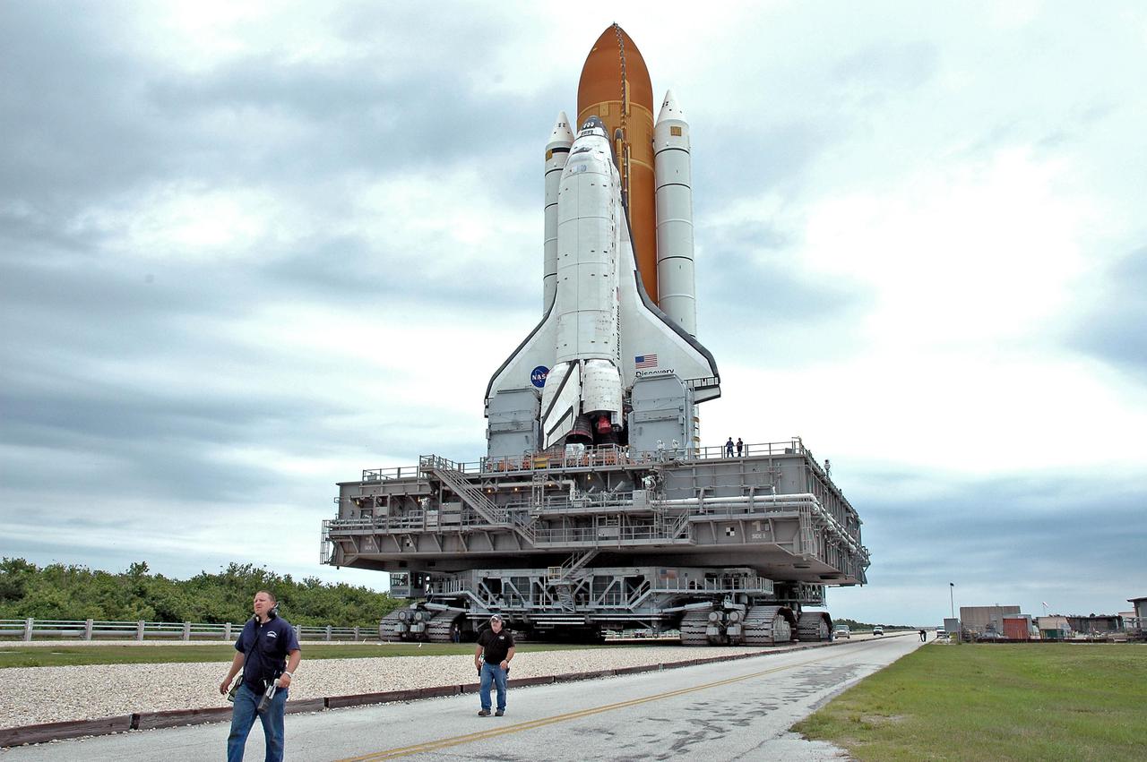 KENNEDY SPACE CENTER, FLA. - Space Shuttle Discovery, resting on the Mobile Launcher Platform atop the Crawler_Transporter, heads along the crawlerway to the Vehicle Assembly Building (VAB). Discovery is rolling back from Launch Pad 39B. Once inside the VAB, Discovery will be demated from its External Tank and lifted into the transfer aisle. On or about June 7, Discovery will be lifted and attached to its new tank and Solid Rocket Boosters, which are already in the VAB. Only the 15th rollback in Space Shuttle Program history, the 4.2-mile journey allows additional modifications to be made to the External Tank prior to a safe Return to Flight. Discovery is expected to be rolled back to the launch pad in mid-June for Return to Flight mission STS-114. The launch window extends from July 13 to July 31.