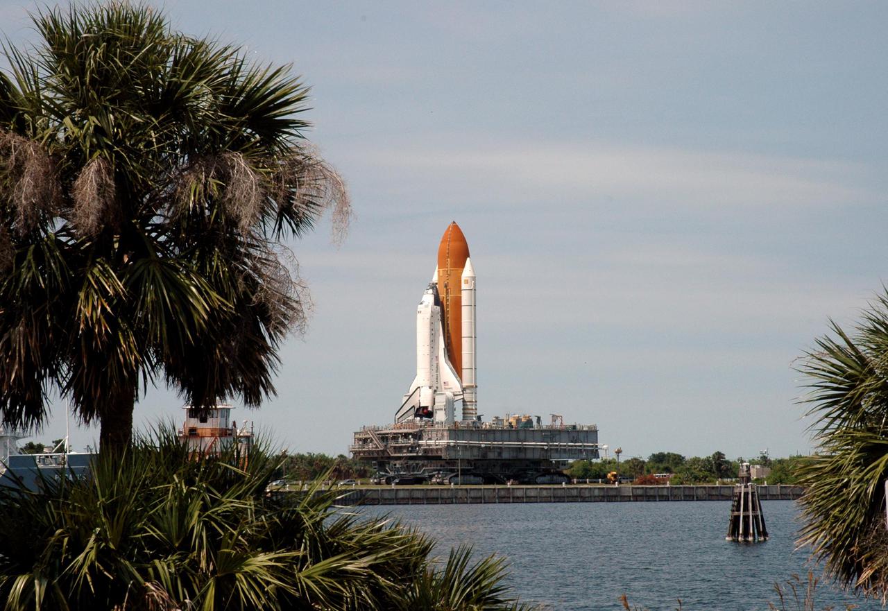 KENNEDY SPACE CENTER, FLA. - Space Shuttle Discovery, atop its Mobile Launcher Platform and Crawler_Transporter, inches its way back to NASA’s Vehicle Assembly Building (VAB) at Kennedy Space Center. Rolling back from Launch Pad 39B, it is passing alongside the turn basin near the VAB. Once inside the VAB, Discovery will be demated from its External Tank and lifted into the transfer aisle. On or about June 7, Discovery will be lifted and attached to its new tank and Solid Rocket Boosters, which are already in the VAB. Only the 15th rollback in Space Shuttle Program history, the 4.2-mile journey allows additional modifications to be made to the External Tank prior to a safe Return to Flight. Discovery is expected to be rolled back to the launch pad in mid-June for Return to Flight mission STS-114. The launch window extends from July 13 to July 31.