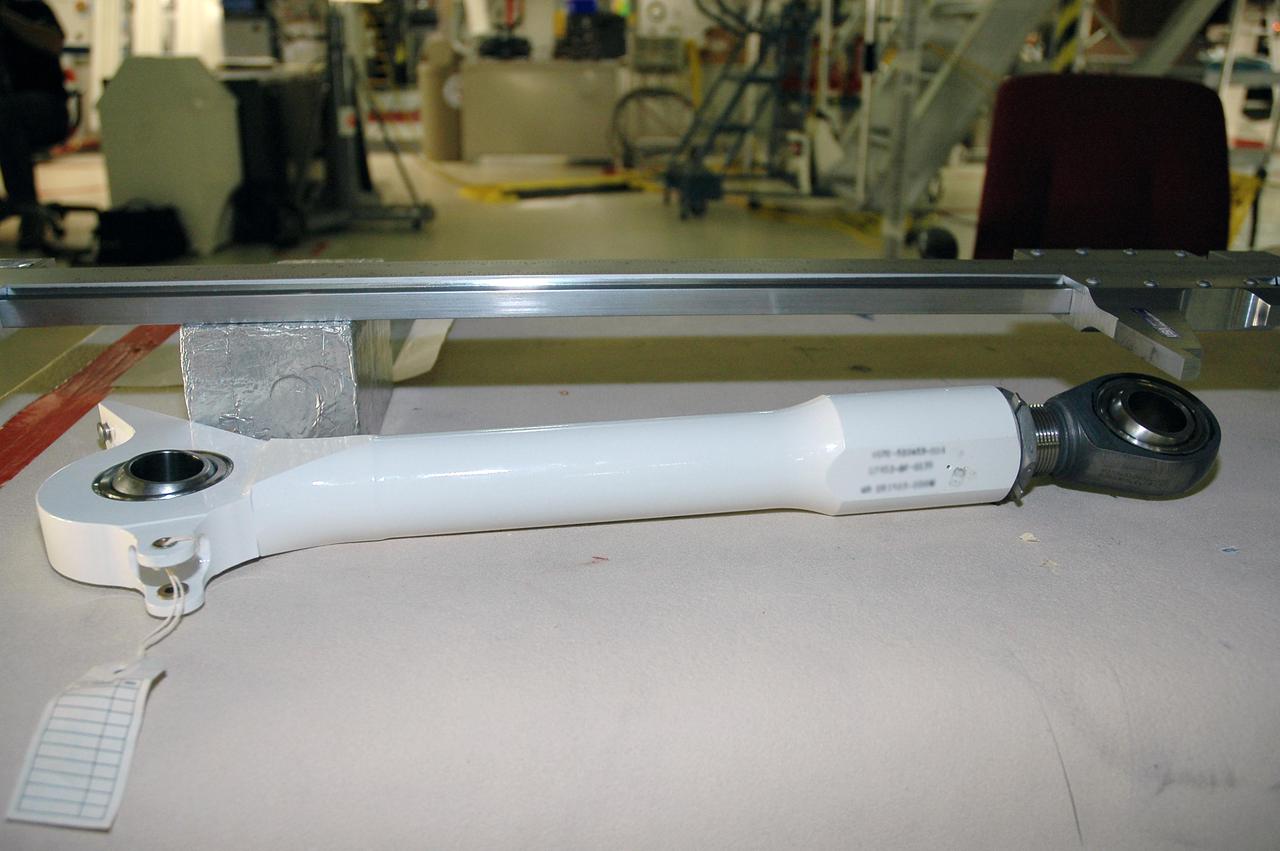 KENNEDY SPACE CENTER, FLA.  -  In the Orbiter Processing Facility at NASA’s Kennedy Space Center, this replacement retract link will be installed on orbiter Atlantis’ right-hand main landing gear.  A small crack was found recently on the retract link assembly.  To lower the main landing gear, a mechanical linkage released by each gear actuates the doors to the open position.  The landing gear reach the full-down and extended position with 10 seconds and are locked in the down position by spring-loaded downlock bungees  Atlantis is scheduled to launch in September 2005 on the second Return to Flight mission, STS-121.