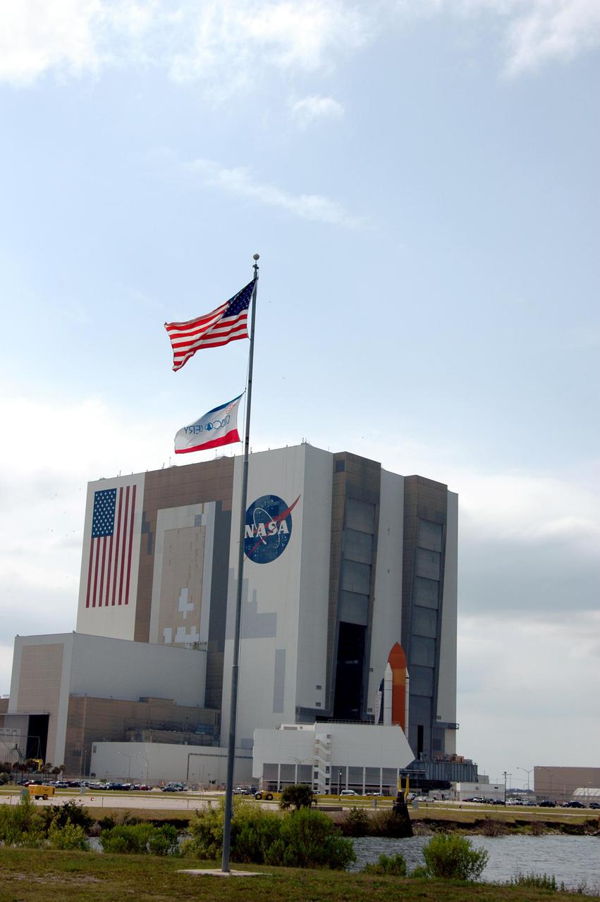 KENNEDY SPACE CENTER, FLA. - Space Shuttle Discovery, atop a Mobile Launcher Platform, nears the opening to high bay 1 in the Vehicle Assembly Building (VAB) at NASA’s Kennedy Space Center. The Shuttle is being rolled back from Launch Pad 39B. Once inside the VAB, Discovery will be demated from its External Tank and lifted into the transfer aisle. On or about June 7, Discovery will be lifted and attached to its new tank and Solid Rocket Boosters, which are already in the VAB. Only the 15th rollback in Space Shuttle Program history, the 4.2-mile journey allows additional modifications to be made to the External Tank prior to a safe Return to Flight. Discovery is expected to be rolled back to the launch pad in mid-June for Return to Flight mission STS-114. The launch window extends from July 13 to July 31.