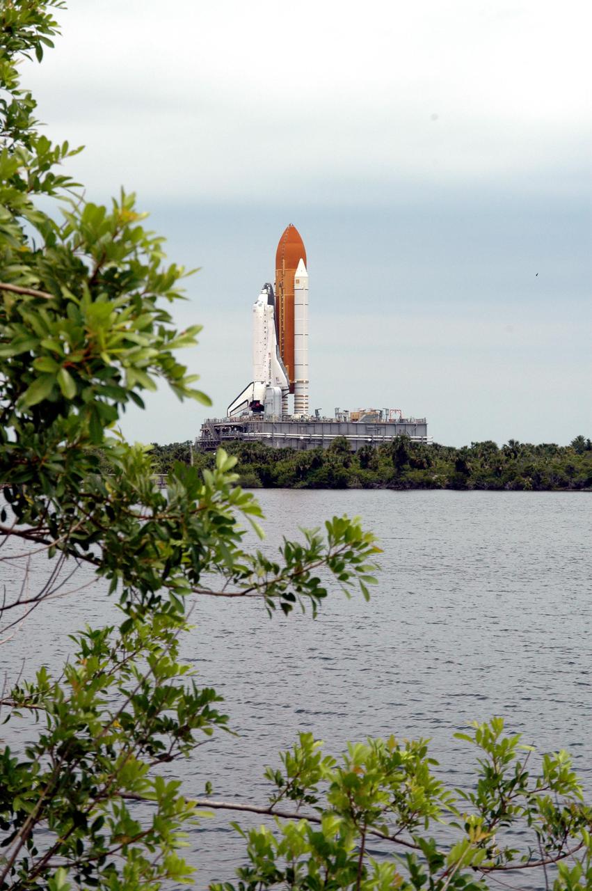 KENNEDY SPACE CENTER, FLA. - Space Shuttle Discovery, atop a Mobile Launcher Platform, makes its way slowly toward the Vehicle Assembly Building (VAB) at NASA’s Kennedy Space Center. The view is across the Turn Basin. The Shuttle is being rolled back from Launch Pad 39B. Once inside the VAB, Discovery will be demated from its External Tank and lifted into the transfer aisle. On or about June 7, Discovery will be lifted and attached to its new tank and Solid Rocket Boosters, which are already in the VAB. Only the 15th rollback in Space Shuttle Program history, the 4.2-mile journey allows additional modifications to be made to the External Tank prior to a safe Return to Flight. Discovery is expected to be rolled back to the launch pad in mid-June for Return to Flight mission STS-114. The launch window extends from July 13 to July 31.