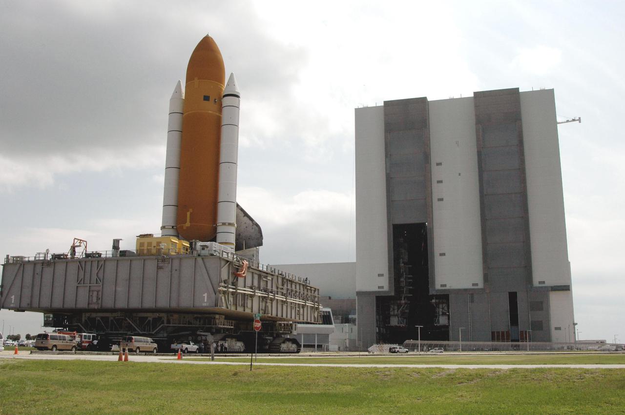 KENNEDY SPACE CENTER, FLA. - Space Shuttle Discovery, atop a Mobile Launcher Platform, nears the opening to high bay 1 in the Vehicle Assembly Building (VAB) at NASA’s Kennedy Space Center. The Shuttle is being rolled back from Launch Pad 39B. Once inside the VAB, Discovery will be demated from its External Tank and lifted into the transfer aisle. On or about June 7, Discovery will be lifted and attached to its new tank and Solid Rocket Boosters, which are already in the VAB. Only the 15th rollback in Space Shuttle Program history, the 4.2-mile journey allows additional modifications to be made to the External Tank prior to a safe Return to Flight. Discovery is expected to be rolled back to the launch pad in mid-June for Return to Flight mission STS-114. The launch window extends from July 13 to July 31.