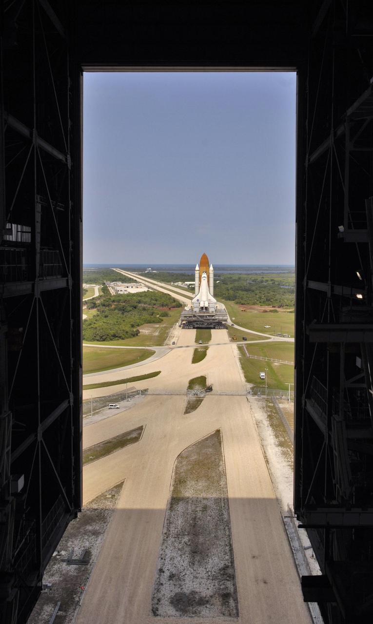 KENNEDY SPACE CENTER, FLA.  -  At NASA’s Kennedy Space Center, Space Shuttle Discovery, resting on the Mobile Launcher Platform, returns to the Vehicle Assembly Building (VAB) along the crawlerway, which seems to stretch to the Atlantic Ocean on the horizon.  Once inside the VAB, it will be demated from its External Tank and lifted into the transfer aisle.  On or about June 7, Discovery will be attached to its new tank and Solid Rocket Boosters, which are already in the VAB.  Only the 15th rollback in Space Shuttle Program history, the 4.2-mile journey allows additional modifications to be made to the External Tank prior to a safe Return to Flight.  Discovery is expected to be rolled back to the launch pad in mid-June for Return to Flight mission STS-114.  The launch window extends from July 13 to July 31. [Photo courtesy of Scott Andrews]