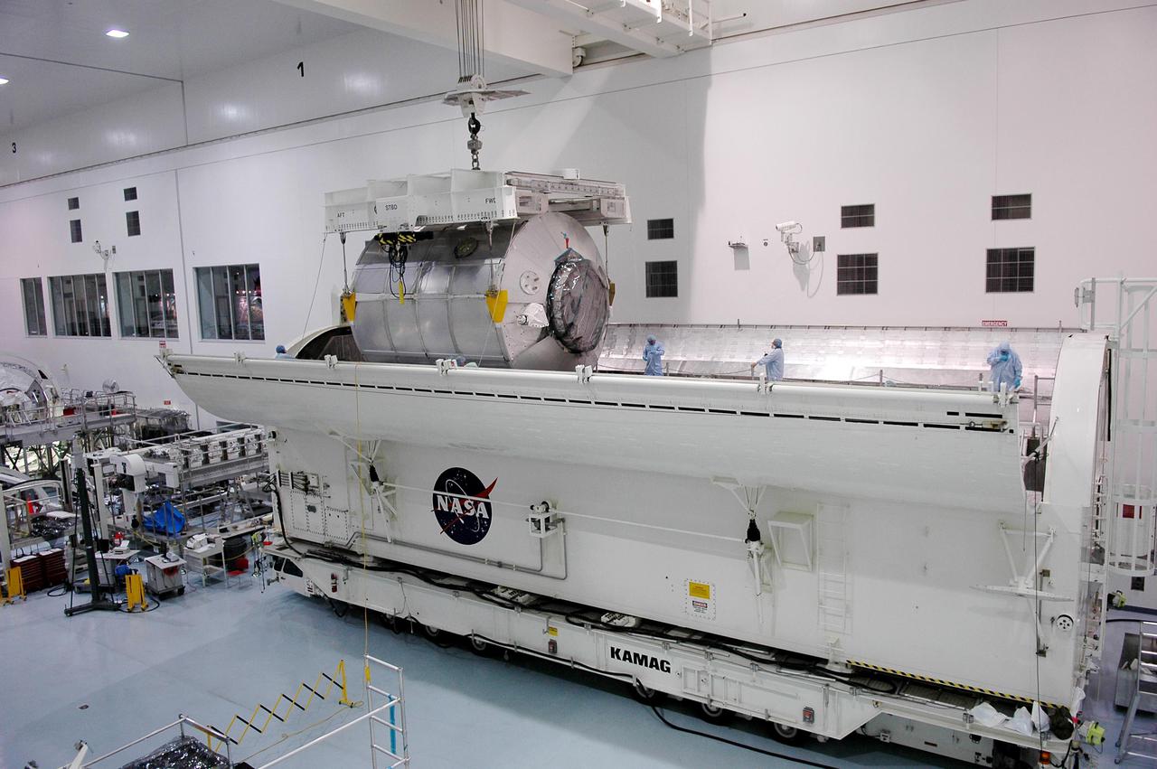 KENNEDY SPACE CENTER, FLA. - In the Space Station Processing Facility at NASA’s Kennedy Space Center, the Multi-Purpose Logistics Module Raffaello is lifted out of the Payload Transportation Canister where it was waiting transfer to the pad. The module is being moved back to its work stand to allow the processing team access in order to address concerns with mechanical fasteners inside the module that do not incorporate an adequate secondary locking feature. The assessment and additional work is being conducted to ensure that the fasteners do not disengage during ascent. Raffaello is scheduled to launch on Discovery's Return to Flight mission STS-114.