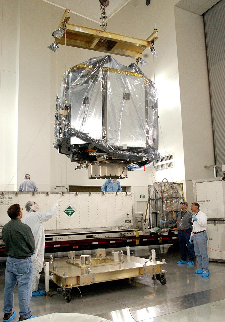 KENNEDY SPACE CENTER, FLA.  - At the Astrotech Payload Processing Facility on Vandenberg Air Force Base in California, an overhead crane lifts the CloudSat spacecraft away from its shipping container.  CloudSat was shipped from Ball Aerospace and Technologies Corp. in Boulder, Colo.   It will be placed on the workstand, seen on the floor in the foreground, and will undergo electrical and spacecraft transmitter testing. In combination with the Cloud-Aerosol Lidar and Infrared Pathfinder Satellite Observation (CALIPSO), the spacecraft will provide never-before-seen 3-D perspectives of how clouds and aerosols form, evolve, and affect weather and climate. CALIPSO and CloudSat will fly in formation with three other satellites to enhance understanding of climate systems.  The launch date for CloudSat_CALIPSO is no earlier than Aug. 22.