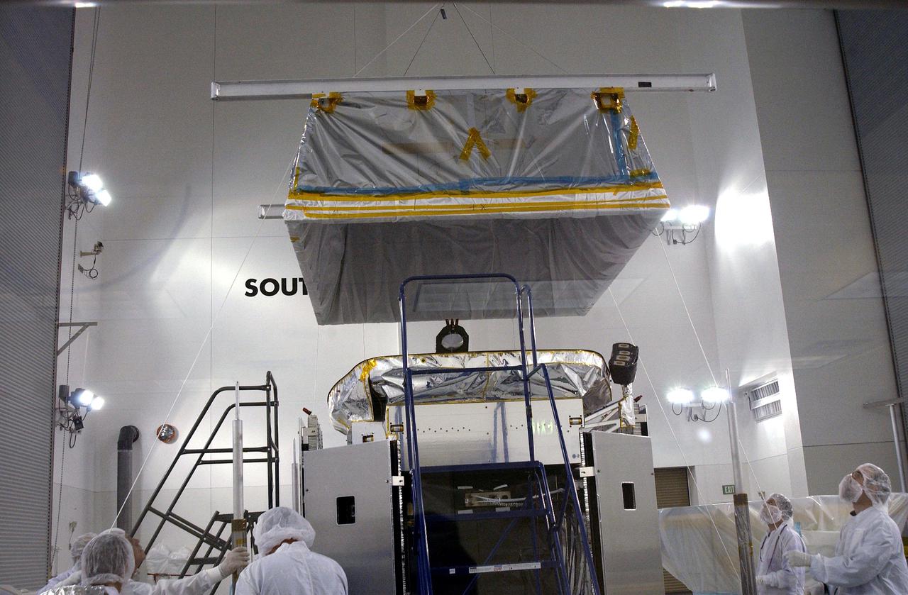 KENNEDY SPACE CENTER, FLA. - In the Astrotech Payload Processing Facility at Vandenberg Air Force Base, workers from NASA’s Jet Propulsion Laboratory in California and Ball Aerospace from Boulder, Colo., lower a 'hat' toward the CloudSat spacecraft before conducting the Cloud Profiling Radar (CPR) functional tests. The hat is used to absorb the RF radiation that is emitted by the instrument during the test. CloudSat will fly in combination with the Cloud-Aerosol Lidar and Infrared Pathfinder Satellite Observation (CALIPSO) to provide never-before-seen 3-D perspectives of how clouds and aerosols form, evolve, and affect weather and climate. CALIPSO and CloudSat will join three other satellites to enhance understanding of climate systems. The launch date for CALIPSO_ CloudSat is no earlier than Aug. 22.