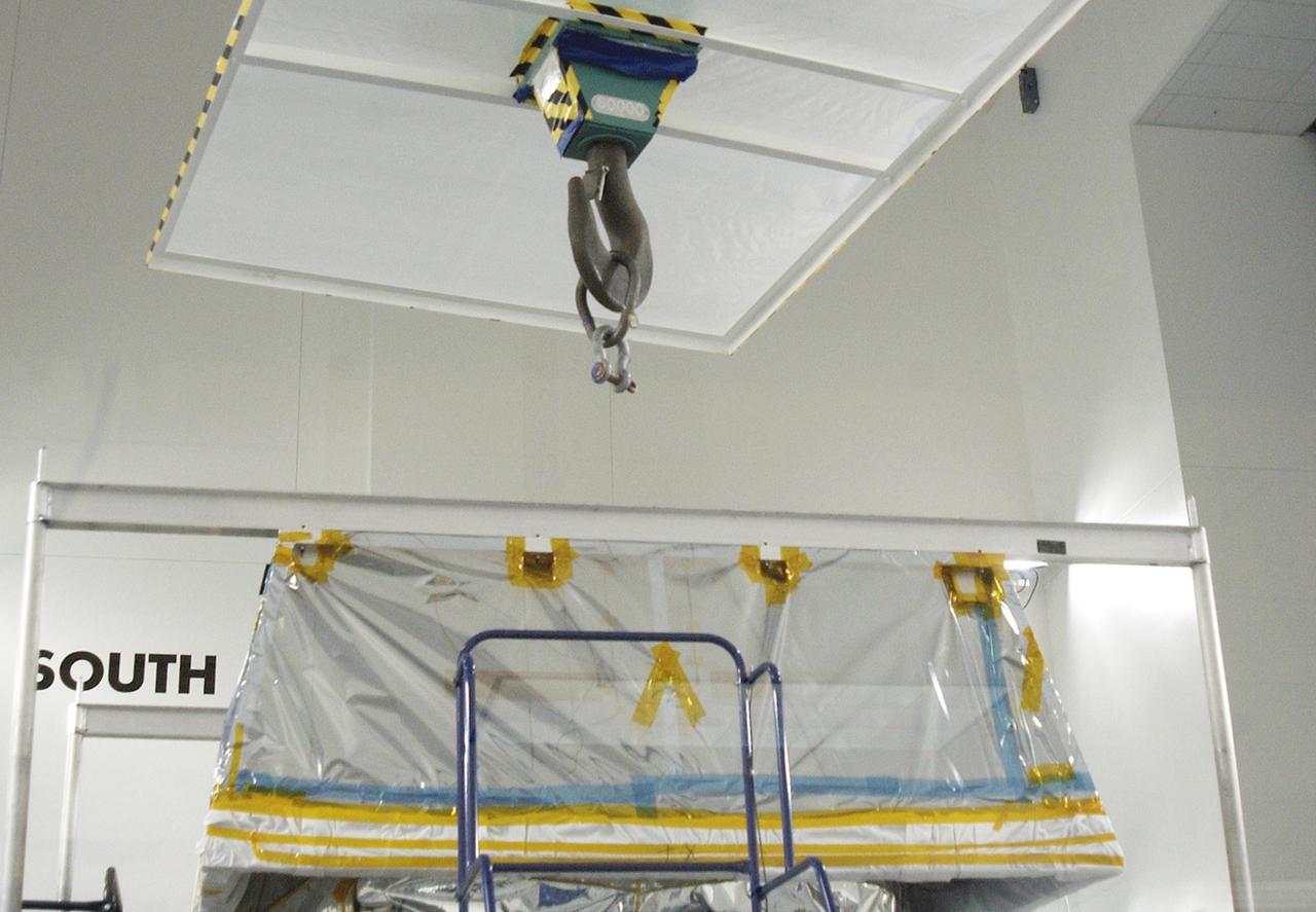 KENNEDY SPACE CENTER, FLA. - In the Astrotech Payload Processing Facility at Vandenberg Air Force Base, the CloudSat spacecraft sports a “hat” seen here that will be used during Cloud Profiling Radar (CPR) functional tests. The hat is used to absorb the RF radiation that is emitted by the instrument during the test. CloudSat will fly in combination with the Cloud-Aerosol Lidar and Infrared Pathfinder Satellite Observation (CALIPSO) to provide never-before-seen 3-D perspectives of how clouds and aerosols form, evolve, and affect weather and climate. CALIPSO and CloudSat will join three other satellites to enhance understanding of climate systems. The launch date for CALIPSO_ CloudSat is no earlier than Aug. 22.