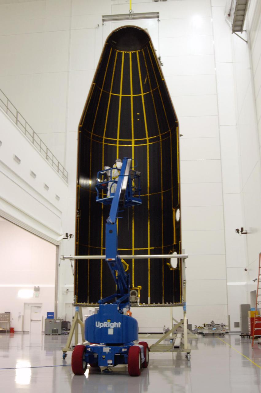 KENNEDY SPACE CENTER, FLA.  - At Astrotech Space Operations in Titusville, Fla., Boeing workers perform cleanliness inspections on the inside of the fairing that will encapsulate the GOES-N spacecraft for launch.  GOES-N, to be launched into orbit for NASA aboard a Boeing Delta IV rocket later this month, was the focus of a media opportunity on June 2. Geostationary Operational Environmental Satellites (GOES) are sponsored by NASA’s Goddard Space Flight Center and the National Oceanic and Atmospheric Administration. Since its arrival on March 11, the satellite has been undergoing final testing by Boeing Satellite Systems of the imaging system, instrumentation, communications and power systems.