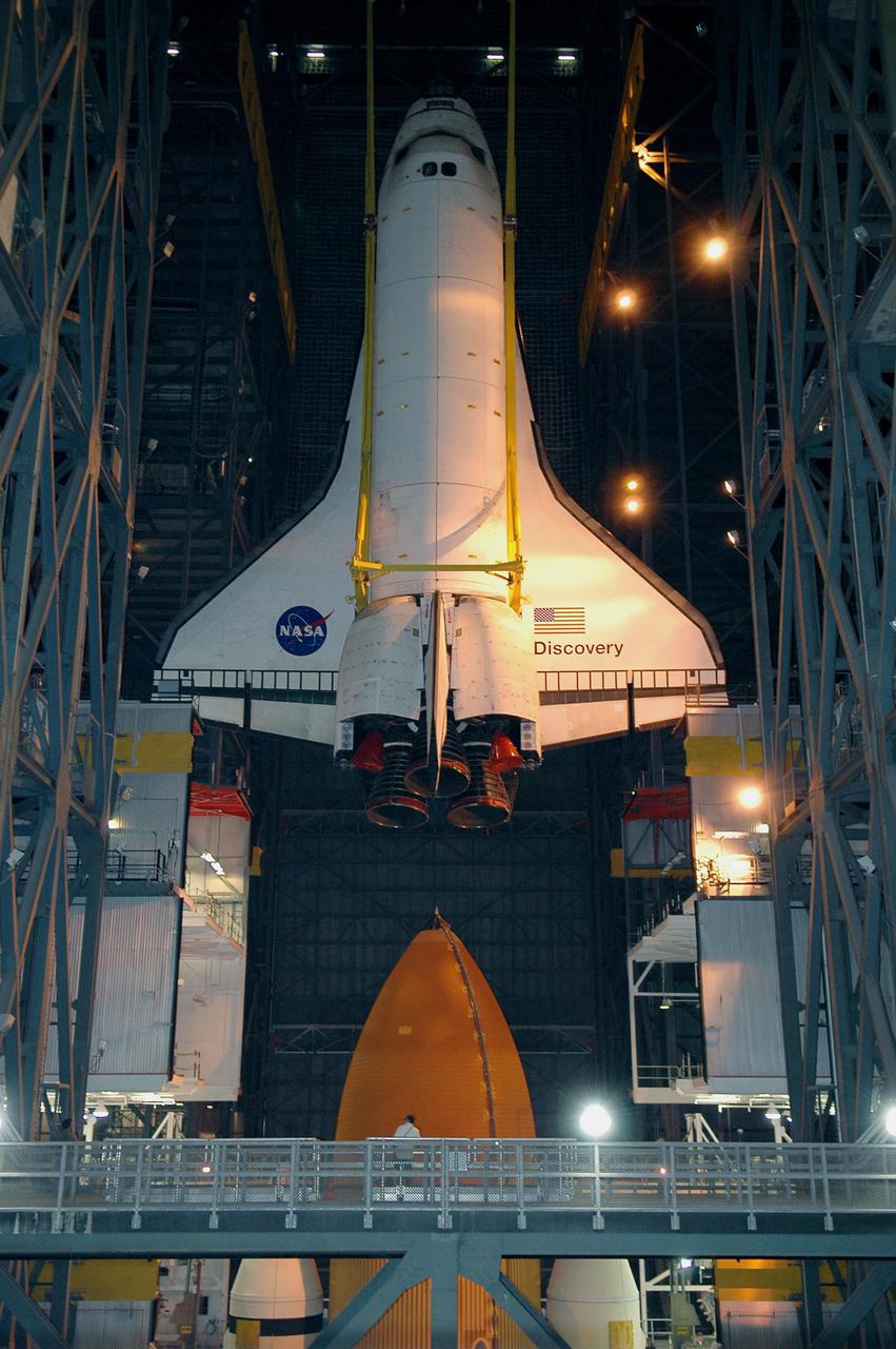 KENNEDY SPACE CENTER, FLA.  - In high bay 1 of the Vehicle Assembly Building at NASA’s Kennedy Space Center, the 122-foot-long orbiter Discovery is lifted above the 154-foot-high External Tank and Solid Rocket Boosters.   After demating from its External Tank (ET), the orbiter will be placed on a transporter in the transfer aisle and moved to high bay 3 for remating with another tank, ET-121.  Discovery is expected to be rolled back to the launch pad in mid-June for Return to Flight mission STS-114.  The launch window extends from July 13 to July 31.