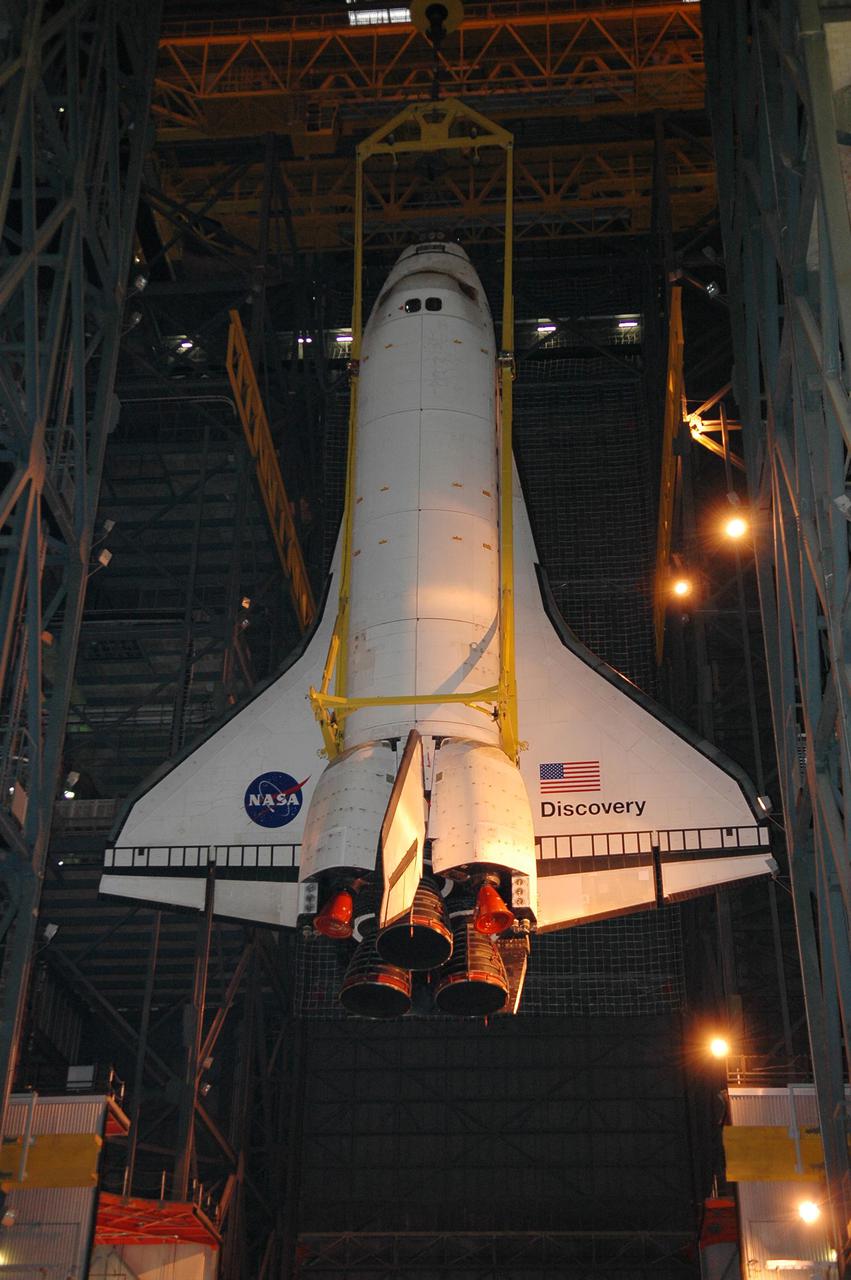 KENNEDY SPACE CENTER, FLA.  - In high bay 1 of the Vehicle Assembly Building at NASA’s Kennedy Space Center, the 122-foot-long orbiter Discovery is suspended in mid-air after being lifted away from the 154-foot-high External Tank and Solid Rocket Boosters.  After demating from its External Tank (ET), the orbiter will be placed on a transporter in the transfer aisle and moved to high bay 3 for remating with another tank, ET-121.  Discovery is expected to be rolled back to the launch pad in mid-June for Return to Flight mission STS-114.  The launch window extends from July 13 to July 31.