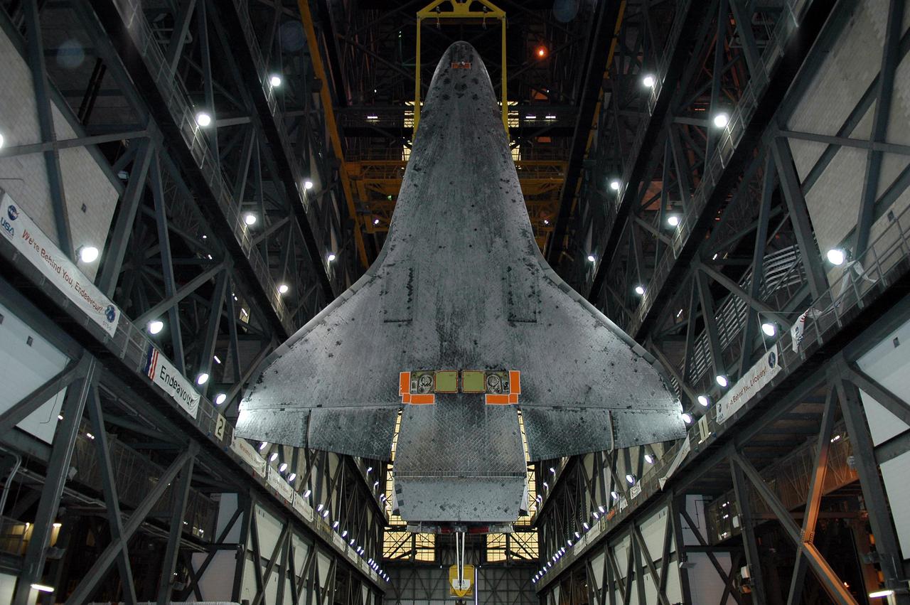 KENNEDY SPACE CENTER, FLA.  -  This view of the suspended 122-foot-long orbiter Discovery shows the underside with the Thermal Protection System tiles that cover it.  After being demated from its External Tank and Solid Rocket Boosters in high bay 1, Discovery is being lowered in the transfer aisle of the Vehicle Assembly Building.  The orbiter will be placed on a transporter and moved to high bay 3 for remating with another tank, ET-121.  Discovery is expected to be rolled back to the launch pad in mid-June for Return to Flight mission STS-114.  The launch window extends from July 13 to July 31.