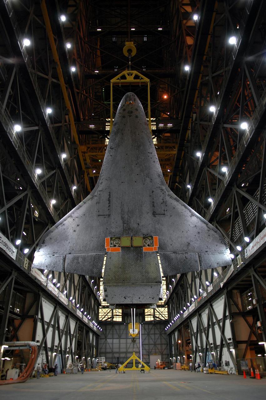 KENNEDY SPACE CENTER, FLA.  -  This view of the suspended 122-foot-long orbiter Discovery shows the underside with the Thermal Protection System tiles that cover it.  After being demated from its External Tank and Solid Rocket Boosters in high bay 1, Discovery is being lowered in the transfer aisle of the Vehicle Assembly Building.  The orbiter will be placed on a transporter and moved to high bay 3 for remating with another tank, ET-121.  Discovery is expected to be rolled back to the launch pad in mid-June for Return to Flight mission STS-114.  The launch window extends from July 13 to July 31.