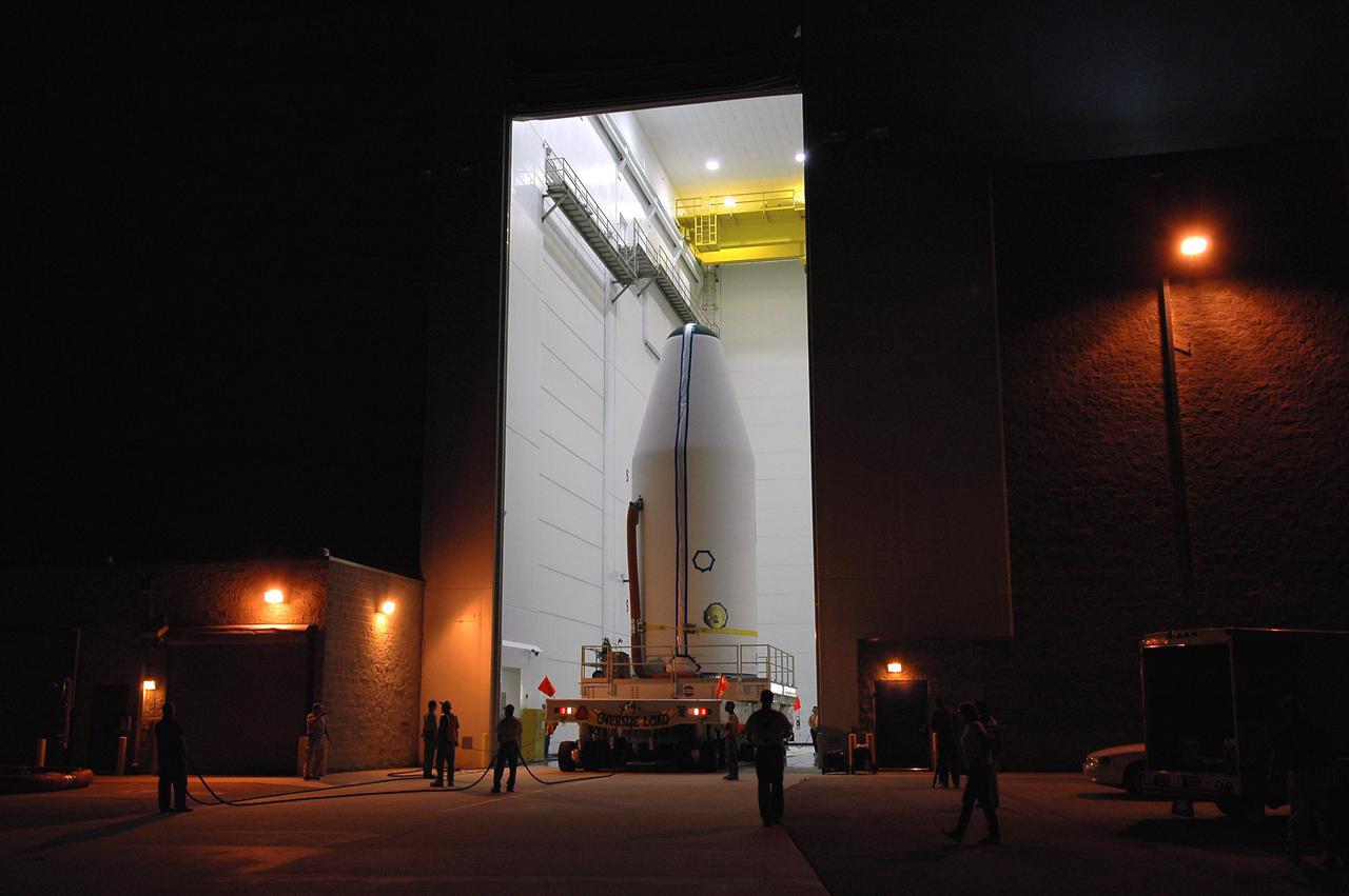 KENNEDY SPACE CENTER, FLA.  -   Through the open door of Astrotech Space Operations in Titusville, Fla., the encapsulated GOES-N spacecraft rolls out during the early morning, heading for Launch Complex 37 at Cape Canaveral Air Force Station.  There it will be mated to the Boeing Delta IV launch vehicle.  The encapsulation protects the spacecraft during liftoff.  Geostationary Operational Environmental Satellites (GOES) are sponsored by NASA’s Goddard Space Flight Center and the National Oceanic and Atmospheric Administration. Launch is scheduled for June 23.