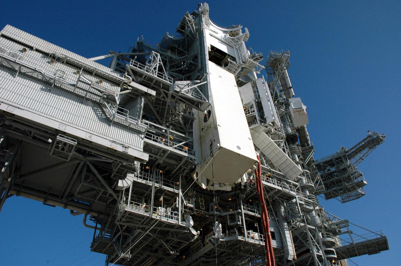 KENNEDY SPACE CENTER, FLA.  -  After dawn on Launch Pad 39B, the payload canister carrying payloads that will launch aboard Space Shuttle Discovery's Return to Flight mission STS-114 is lifted up to the Payload Changeout Room.  There the payloads will be removed.  Discovery’s payloads include the Multi-Purpose Logistics Module Raffaello, the Lightweight Multi-Purpose Experiment Support Structure Carrier (LMC), and the External Stowage Platform-2 (ESP-2).  Raffaello will deliver supplies to the International Space Station including food, clothing and research equipment.  The LMC will carry a replacement Control Moment Gyroscope and a tile repair sample box.  The ESP-2 is outfitted with replacement parts.  Discovery’s launch window extends from July 13 through July 31.