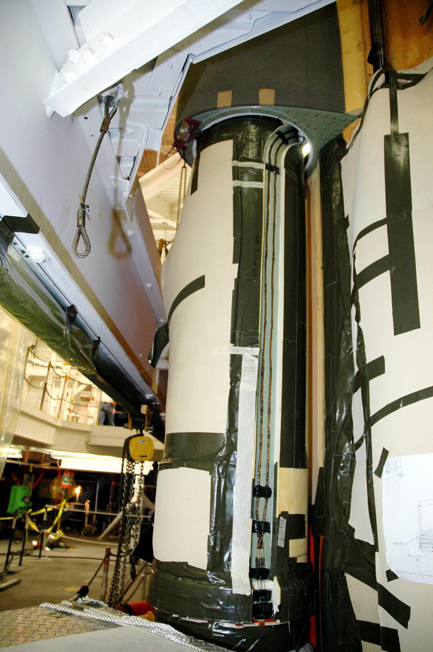 KENNEDY SPACE CENTER, FLA. - In the Vehicle Assembly Building at NASA’s Kennedy Space Center, the newly installed liquid oxygen bellows heater is seen on External Tank 120, recently removed from the orbiter Discovery. The new heater has been added to the feedline bellows to minimize the potential for ice and frost buildup.  ET-120 will fly with Atlantis on the second Return to Flight mission STS-121.  The launch window for STS-121 extends from Sept. 9 - 24.