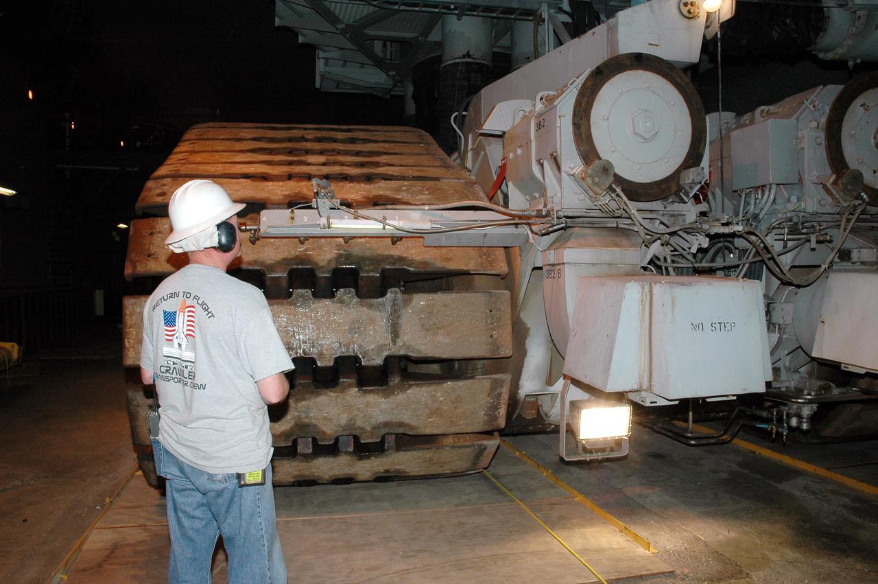 KENNEDY SPACE CENTER, FLA. - In the Vehicle Assembly Building (VAB) at NASA’s Kennedy Space Center, a technician monitors the preparations for a Crawler-Transporter to move Space Shuttle Discovery from high bay 3 to Launch Pad 39B, a 4-mile, 6-hour journey.  First motion was at 1:58 a.m. EDT. The Space Shuttle rests on a Mobile Launcher Platform which sits atop the Crawler-Transporter.  This is the second rollout of Discovery after being returned to the Vehicle Assembly Building for connection to an improved External Tank.  Launch of Discovery on its Return to Flight mission STS-114 is targeted for a launch window extending from July 13 to July 31. During its 12-day mission, Discovery’s seven-person crew will test new hardware and techniques to improve Shuttle safety, as well as deliver supplies to the International Space Station.