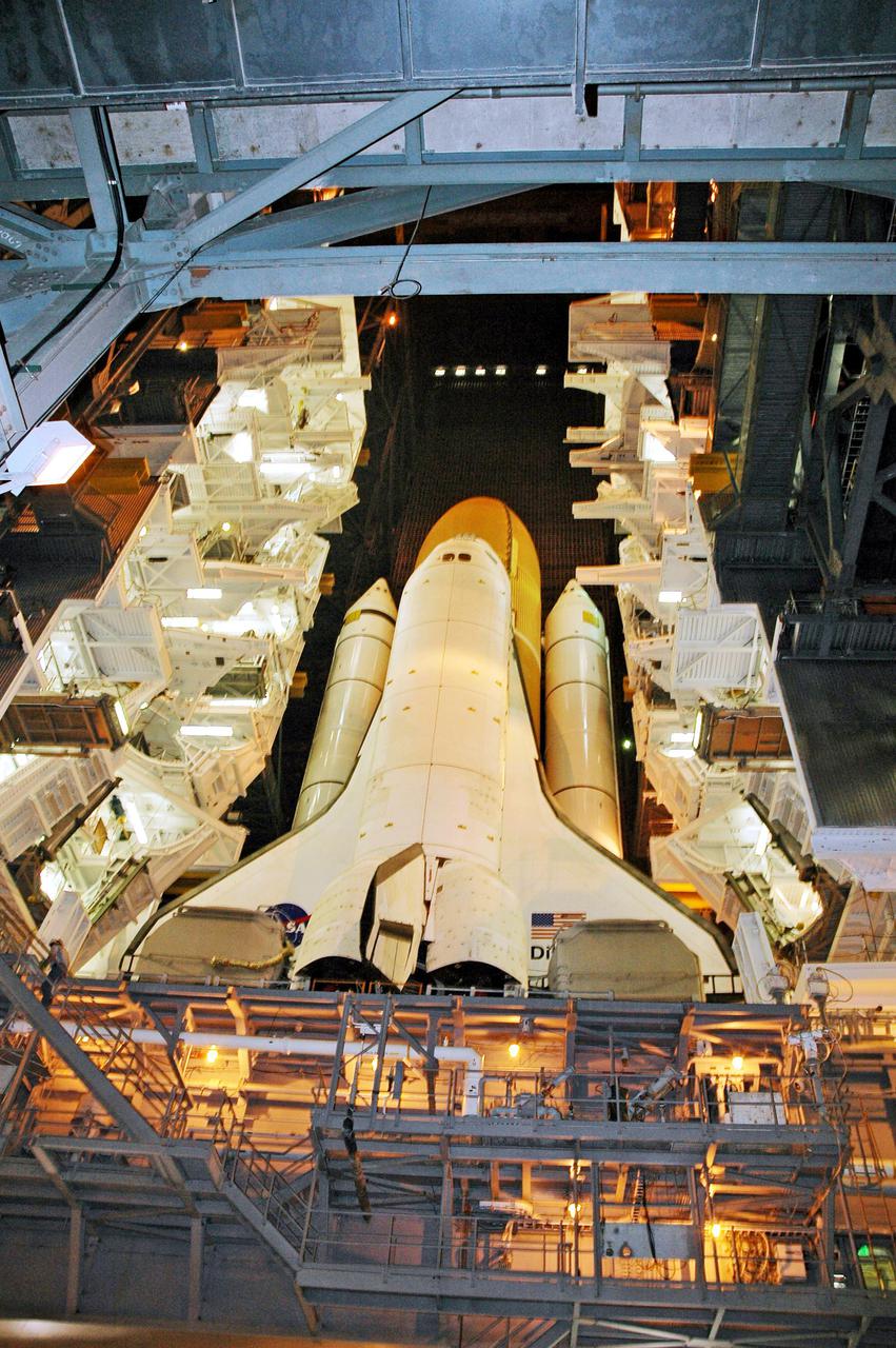 KENNEDY SPACE CENTER, FLA. - In the Vehicle Assembly Building (VAB) at NASA’s Kennedy Space Center, Space Shuttle Discovery awaits the start of its trip from high bay 3 to Launch Pad 39B, a 4-mile, 6-hour journey.  First motion was at 1:58 a.m. EDT. The Space Shuttle rests on a Mobile Launcher Platform which sits atop a Crawler-Transporter.  This is the second rollout of Discovery after being returned to the Vehicle Assembly Building for connection to an improved External Tank.  Launch of Discovery on its Return to Flight mission STS-114 is targeted for a launch window extending from July 13 to July 31. During its 12-day mission, Discovery’s seven-person crew will test new hardware and techniques to improve Shuttle safety, as well as deliver supplies to the International Space Station.