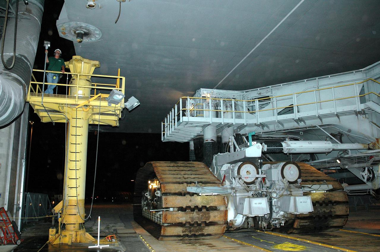KENNEDY SPACE CENTER, FLA. - In the Vehicle Assembly Building (VAB) at NASA’s Kennedy Space Center, a technician monitors the clearance of a Crawler-Transporter as it moves Space Shuttle Discovery out of high bay 3 to Launch Pad 39B, a 4-mile, 6-hour journey.  First motion was at 1:58 a.m. EDT. The Space Shuttle rests on a Mobile Launcher Platform which sits atop the Crawler-Transporter.  This is the second rollout of Discovery after being returned to the Vehicle Assembly Building for connection to an improved External Tank.  Launch of Discovery on its Return to Flight mission STS-114 is targeted for a launch window extending from July 13 to July 31. During its 12-day mission, Discovery’s seven-person crew will test new hardware and techniques to improve Shuttle safety, as well as deliver supplies to the International Space Station.