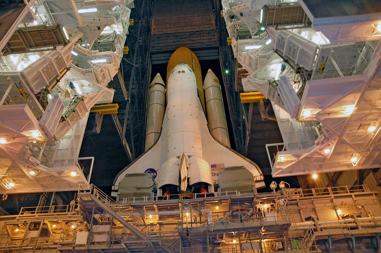 KENNEDY SPACE CENTER, FLA. - In the Vehicle Assembly Building (VAB) at NASA’s Kennedy Space Center, Space Shuttle Discovery begins its trip from high bay 3 to Launch Pad 39B, a 4-mile, 6-hour journey.  First motion was at 1:58 a.m. EDT. The Space Shuttle rests on a Mobile Launcher Platform which sits atop a Crawler-Transporter.  This is the second rollout of Discovery after being returned to the Vehicle Assembly Building for connection to an improved External Tank.  Launch of Discovery on its Return to Flight mission STS-114 is targeted for a launch window extending from July 13 to July 31. During its 12-day mission, Discovery’s seven-person crew will test new hardware and techniques to improve Shuttle safety, as well as deliver supplies to the International Space Station.