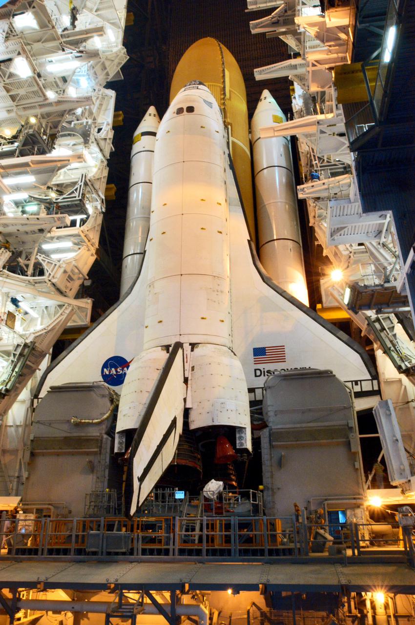 KENNEDY SPACE CENTER, FLA. - In the Vehicle Assembly Building (VAB) at NASA’s Kennedy Space Center, Space Shuttle Discovery exits high bay 3 to begin its trip to Launch Pad 39B, a 4-mile, 6-hour journey.  First motion was at 1:58 a.m. EDT. The Space Shuttle rests on a Mobile Launcher Platform which sits atop a Crawler-Transporter.  This is the second rollout of Discovery after being returned to the Vehicle Assembly Building for connection to an improved External Tank.  Launch of Discovery on its Return to Flight mission STS-114 is targeted for a launch window extending from July 13 to July 31. During its 12-day mission, Discovery’s seven-person crew will test new hardware and techniques to improve Shuttle safety, as well as deliver supplies to the International Space Station.