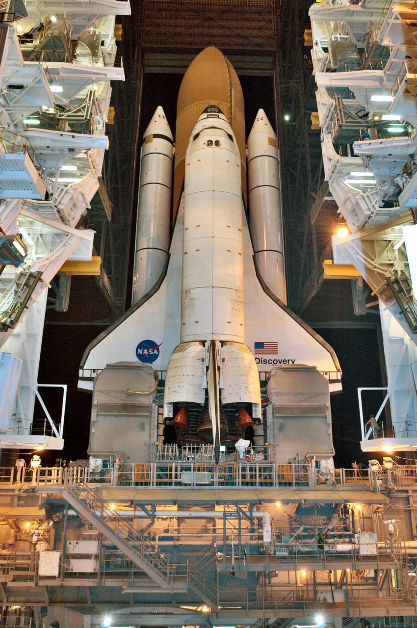 KENNEDY SPACE CENTER, FLA. - In the Vehicle Assembly Building (VAB) at NASA’s Kennedy Space Center, Space Shuttle Discovery exits high bay 3 to begin its trip to Launch Pad 39B, a 4-mile, 6-hour journey.  First motion was at 1:58 a.m. EDT. The Space Shuttle rests on a Mobile Launcher Platform which sits atop a Crawler-Transporter.  This is the second rollout of Discovery after being returned to the Vehicle Assembly Building for connection to an improved External Tank.  Launch of Discovery on its Return to Flight mission STS-114 is targeted for a launch window extending from July 13 to July 31. During its 12-day mission, Discovery’s seven-person crew will test new hardware and techniques to improve Shuttle safety, as well as deliver supplies to the International Space Station.