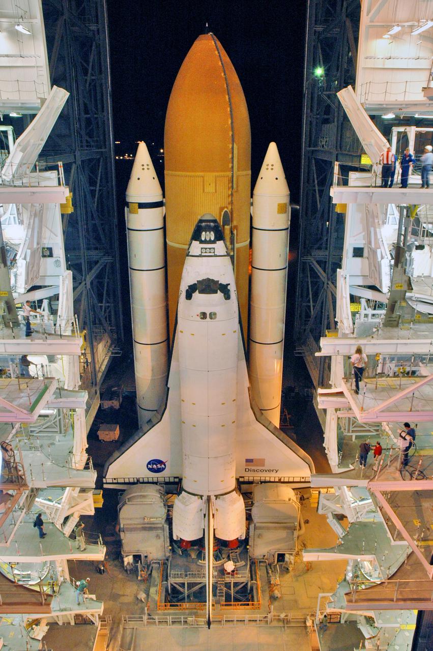 KENNEDY SPACE CENTER, FLA. - In the Vehicle Assembly Building (VAB) at NASA’s Kennedy Space Center, Space Shuttle Discovery begins its trip from high bay 3 to Launch Pad 39B, a 4-mile, 6-hour journey.  First motion was at 1:58 a.m. EDT. The Space Shuttle rests on a Mobile Launcher Platform which sits atop a Crawler-Transporter.  This is the second rollout of Discovery after being returned to the Vehicle Assembly Building for connection to an improved External Tank.  Launch of Discovery on its Return to Flight mission STS-114 is targeted for a launch window extending from July 13 to July 31. During its 12-day mission, Discovery’s seven-person crew will test new hardware and techniques to improve Shuttle safety, as well as deliver supplies to the International Space Station.