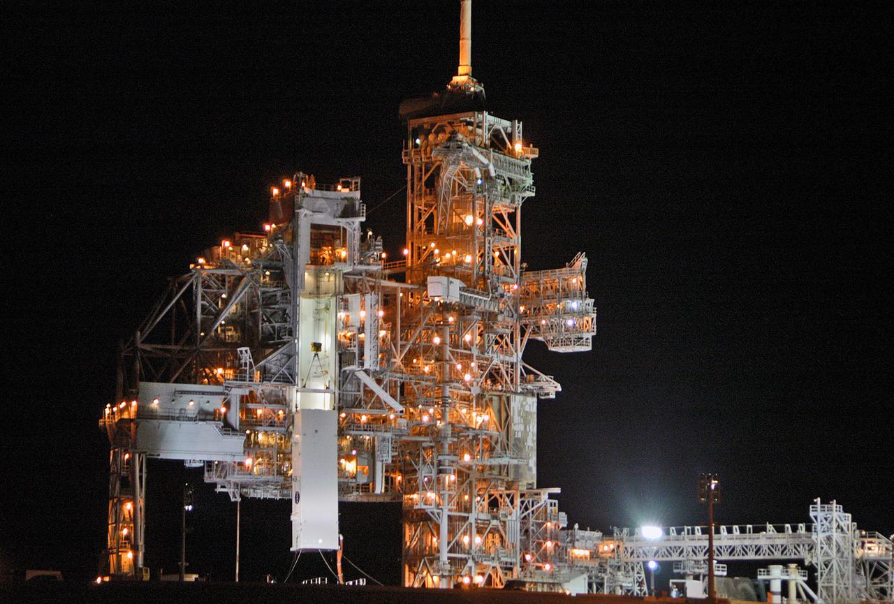KENNEDY SPACE CENTER, FLA. - At Launch Pad 39B, the payload canister that delivered payloads launching aboard Space Shuttle Discovery's Return to Flight mission STS-114 is lowered from the Payload Changeout Room. The payloads will be installed into Discovery, scheduled to arrive at the pad later today. Discovery’s payloads include the Multi-Purpose Logistics Module Raffaello, the Lightweight Multi-Purpose Experiment Support Structure Carrier (LMC), and the External Stowage Platform-2 (ESP-2). Raffaello will deliver supplies to the International Space Station including food, clothing and research equipment. The LMC will carry a replacement Control Moment Gyroscope and a tile repair sample box. The ESP-2 is outfitted with replacement parts. Discovery’s launch window extends from July 13 through July 31.