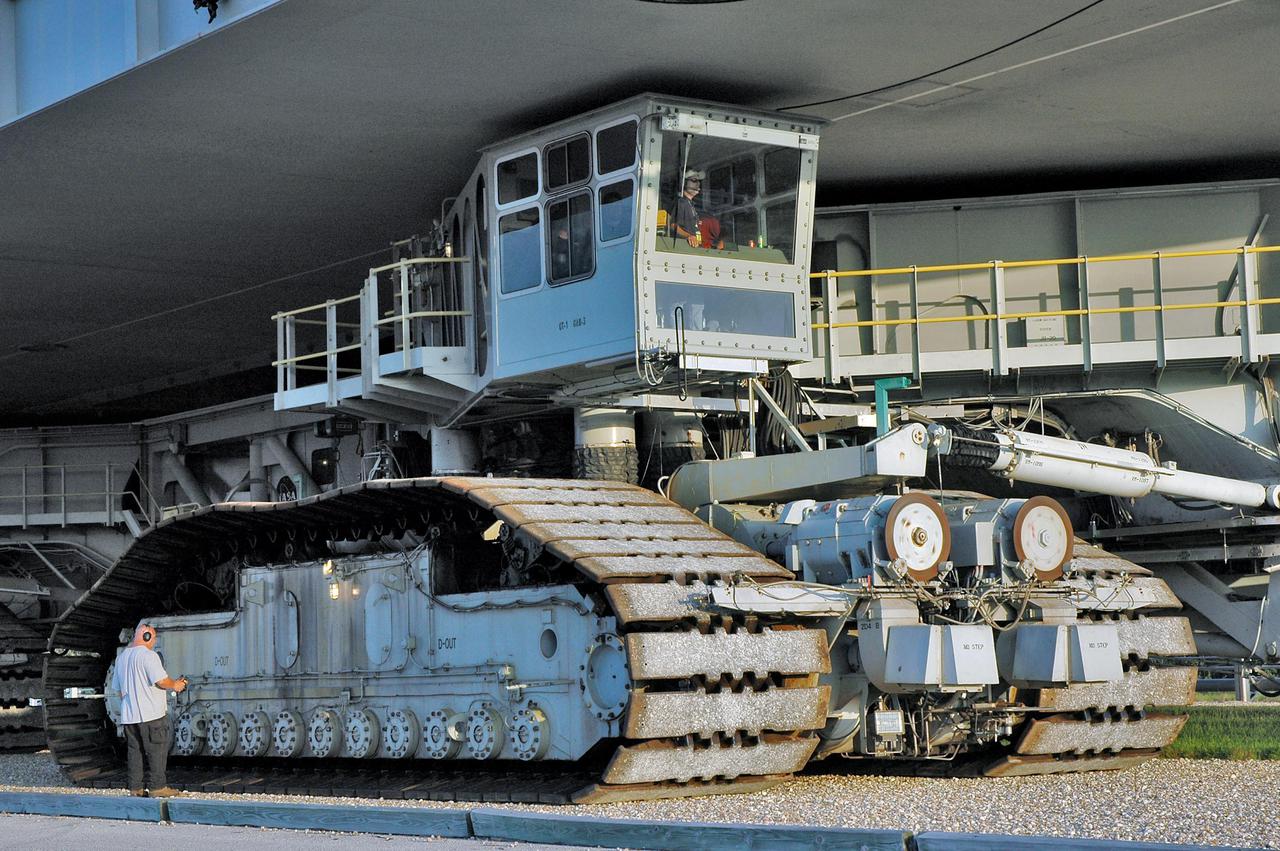 KENNEDY SPACE CENTER, FLA. - The Crawler-Transporter carries Space Shuttle Discovery and the Mobile Launcher Platform to Launch Pad 39B. The crawler is operated by a United Space Alliance driver, seen in the cab above the crawler tracks. The transporter uses a laser guidance system and a leveling system for the journey that keeps the top of the Space Shuttle vertical. This is the second rollout of Discovery after being returned to the Vehicle Assembly Building for connection to an improved External Tank. Launch of Discovery on its Return to Flight mission STS-114 is targeted for a launch window extending from July 13 to July 31.