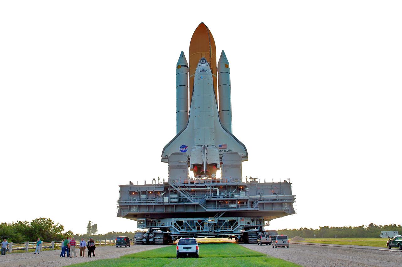 KENNEDY SPACE CENTER, FLA. - Space Shuttle Discovery makes its way along the crawlerway to Launch Pad 39B. First motion for the 4-mile, 6-hour journey was at 1:58 a.m. EDT. The Space Shuttle rests on a Mobile Launcher Platform that sits atop a Crawler-Transporter. This is the second rollout of Discovery after being returned to the Vehicle Assembly Building for connection to an improved External Tank. Launch of Discovery on its Return to Flight mission STS-114 is targeted for a launch window extending from July 13 to July 31.