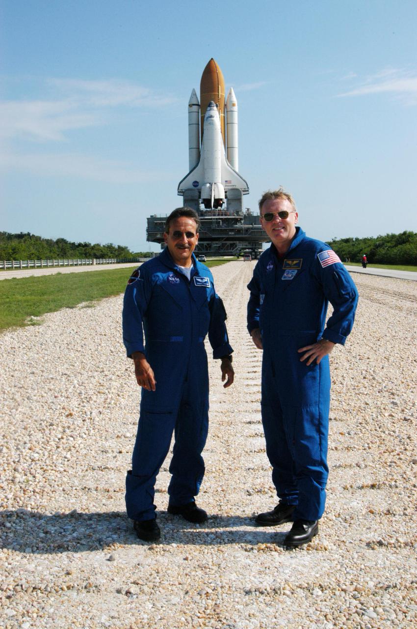 KENNEDY SPACE CENTER, FLA. - STS-114 Mission Specialists Charles Camarda (left) and Andrew Thomas monitor the progress of Space Shuttle Discovery as it makes its way along the crawlerway to Launch Pad 39B. First motion for the 4.2-mile journey was at 1:58 a.m. EDT. The Space Shuttle rests on a Mobile Launcher Platform that sits atop a Crawler-Transporter. This is the second rollout of Discovery. The vehicle was returned to the Vehicle Assembly Building for connection to an improved External Tank. Launch of Discovery on its Return to Flight mission STS-114 is targeted for a launch window extending from July 13 to July 31.