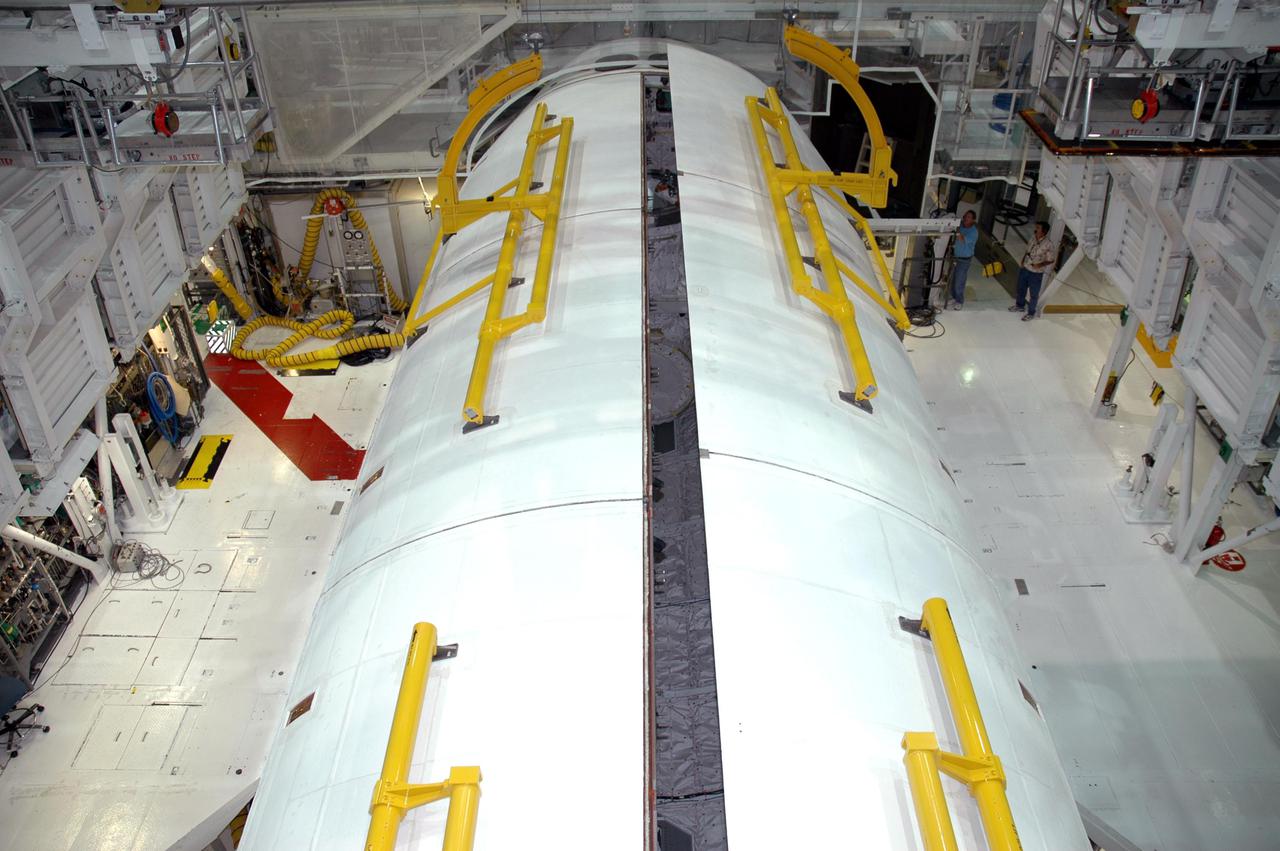KENNEDY SPACE CENTER, FLA. - In the Orbiter Processing Facility at Kennedy Space Center in Florida, the payload bay doors of the orbiter Atlantis are nearly closed. Atlantis is scheduled to fly on the second Return to Flight mission, STS-121, targeted for launch in a window extending from Sept. 9 to Sept. 24.