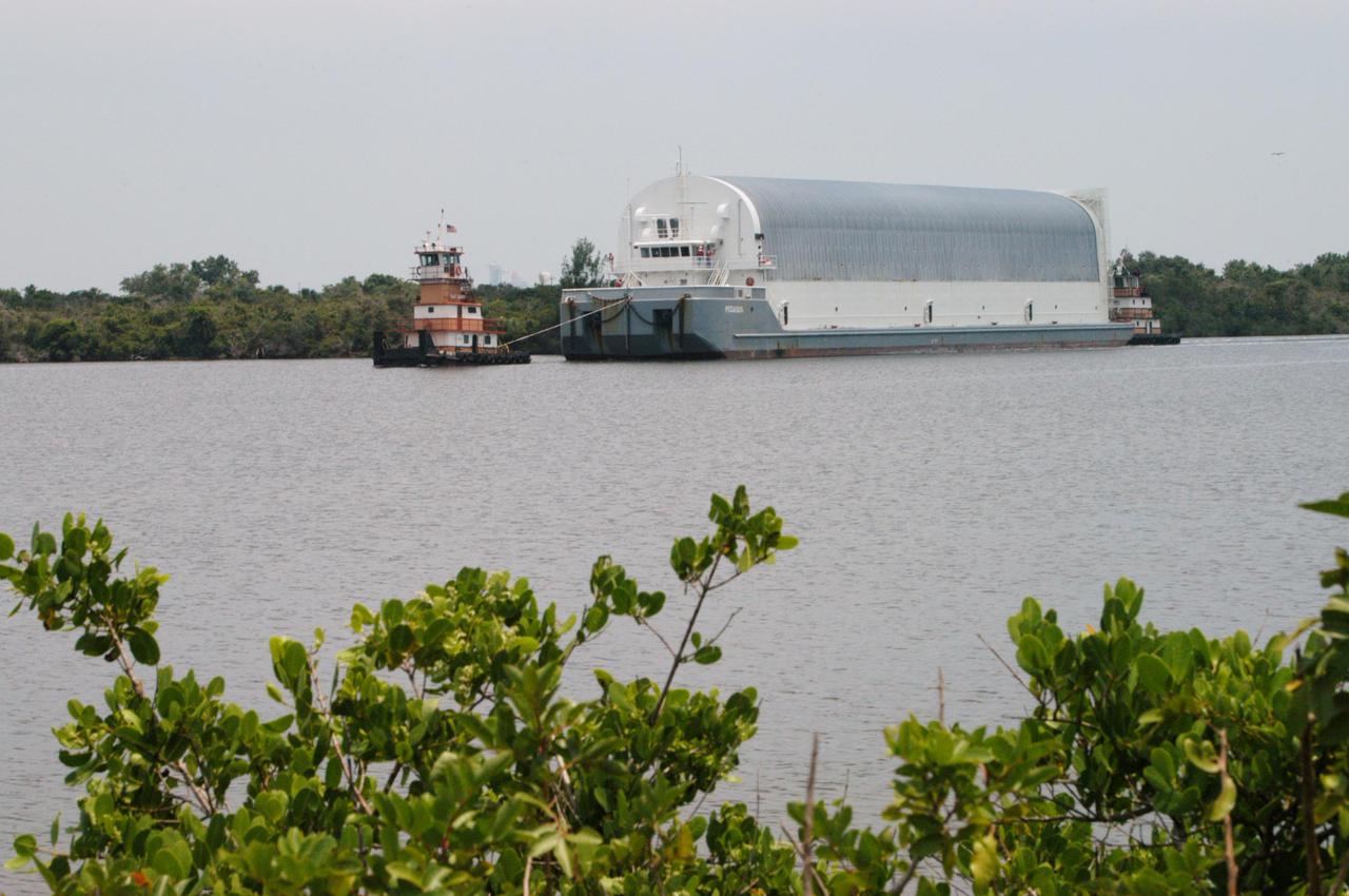 KENNEDY SPACE CENTER, FLA. -  A barge carrying a new External Tank (ET) arrives at the Turn Basin in the Launch Complex 39 Area.   Designated ET-119, the tank will be used on a future Space Shuttle launch.  After being offloaded, the tank will be transported to the Vehicle Assembly Building.  The barge was towed on a 900-mile journey at sea from the Michoud Assembly Facility in New Orleans by one of NASA’s Solid Rocket Booster Retrieval Ships.