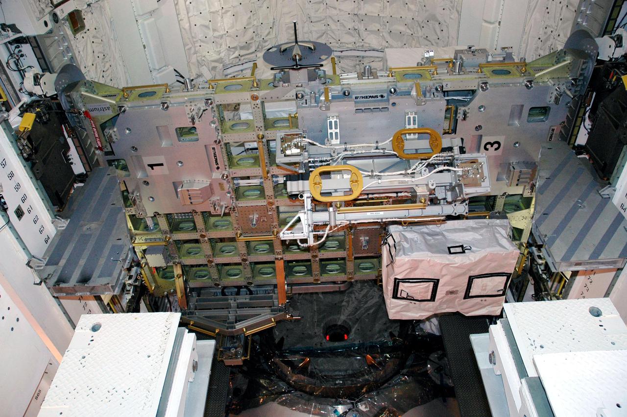 KENNEDY SPACE CENTER, FLA. - In the Payload Changeout Room on Launch Pad 39B, the payloads for Return to Flight mission STS-114 are being transferred to Discovery’s payload bay.  Seen here is the External Stowage Platform 2.  Other payloads includes a Control Moment Gyro and the Thermal Protection System Detailed Test Objective box, which is placed on the Lightweight Multi-Purpose Experiment Support Structure Carrier, and Multi-Purpose Logistics Module Raffaello. Already installed in the payload bay are the airlock, the Canadarm 2, or Shuttle arm, and the Orbiter Boom Sensor System.  The launch window for mission STS-114 extends from July 13 to July 31.